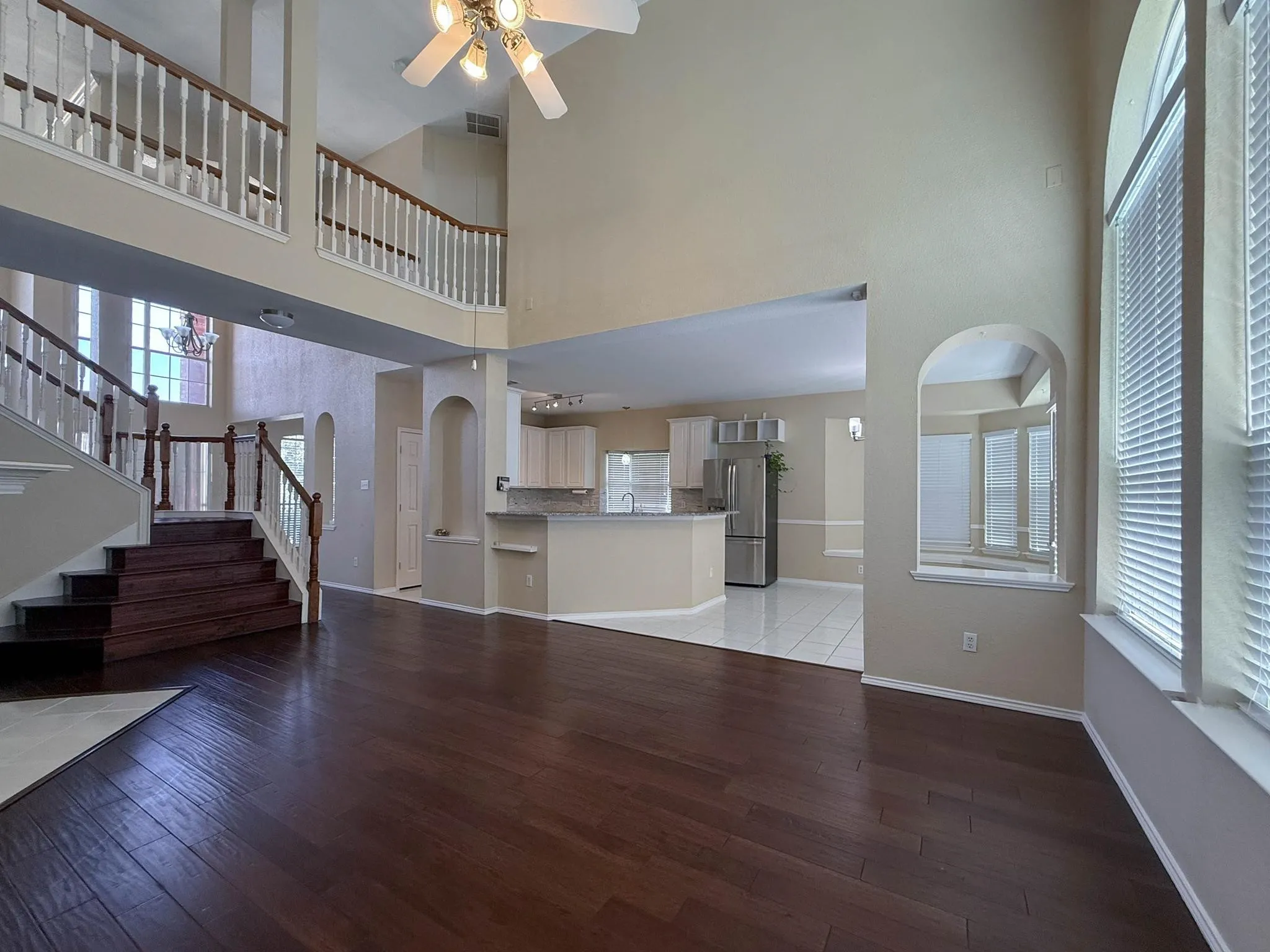 Family room with soaring ceilings and wood floors.