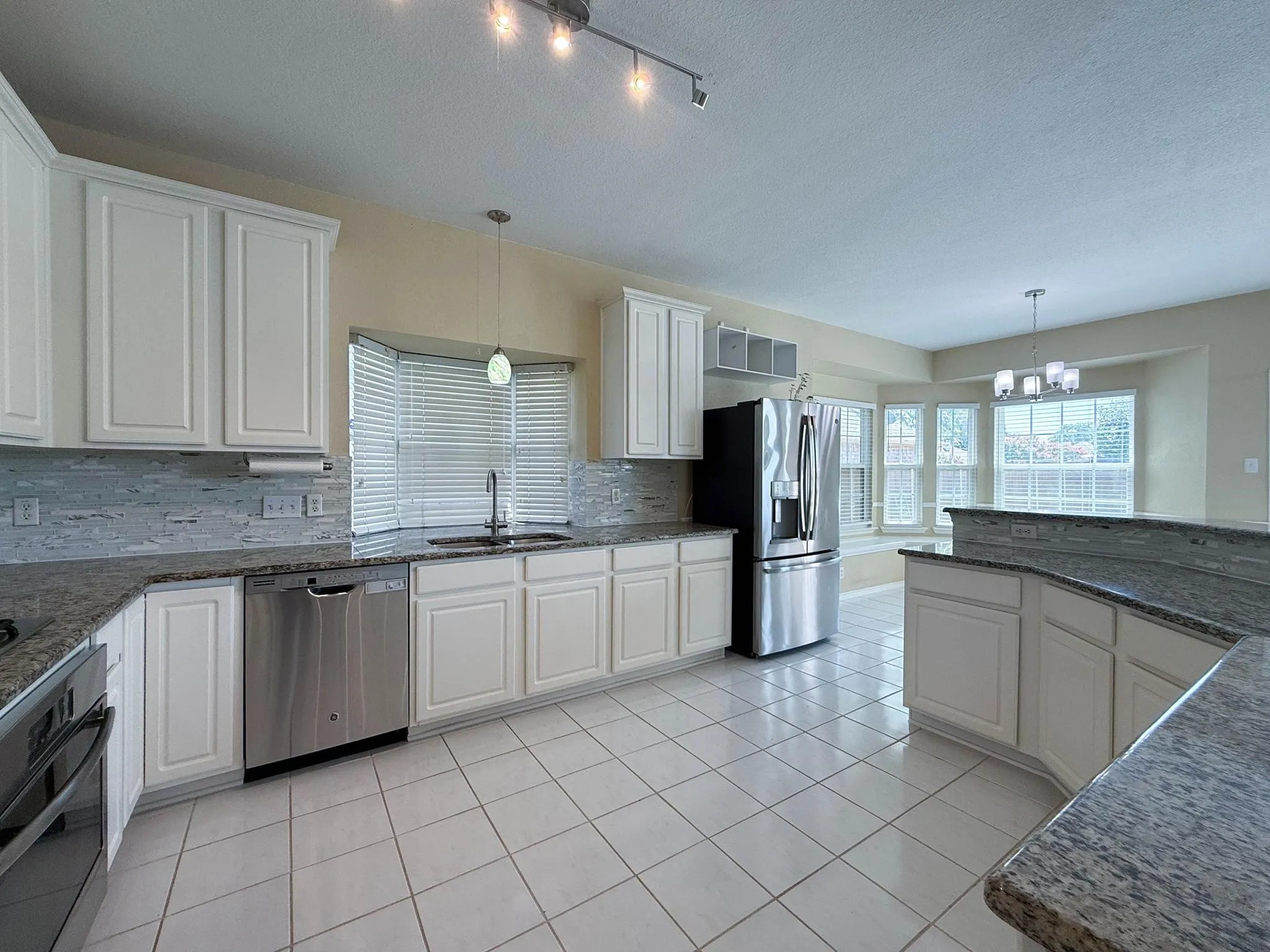 Kitchen with Stainless Refrigerator, dishwasher & Oven.