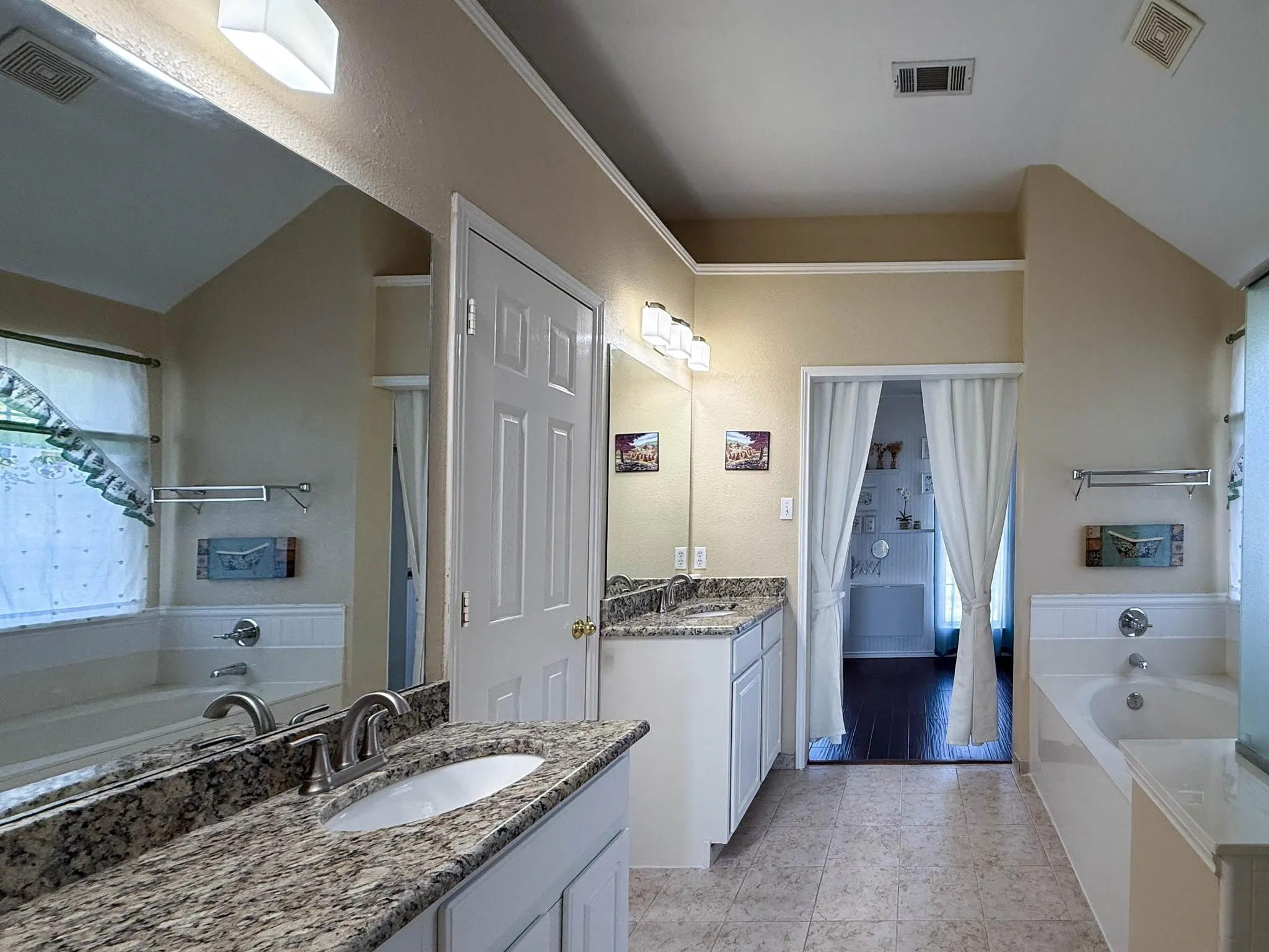 Primary Bath with separate vanities, granite counters, garden tub and separate shower