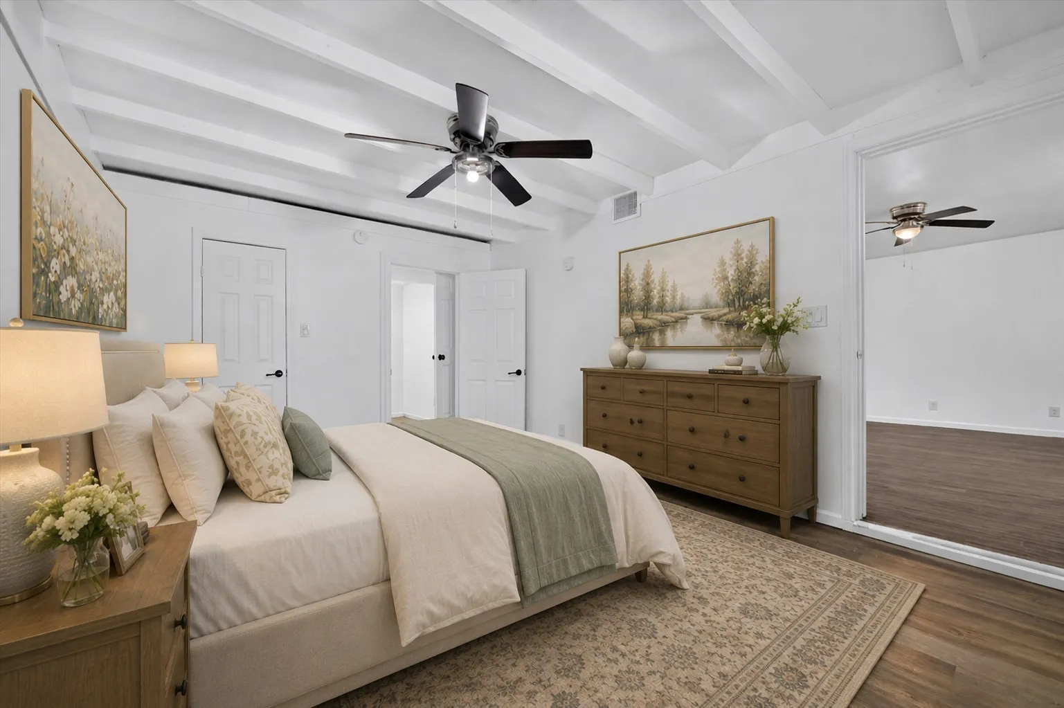Virtually staged Exposed white ceiling beams, ceiling fan, wood-finish flooring, two paneled interior doors, and a full-height mirrored closet door
