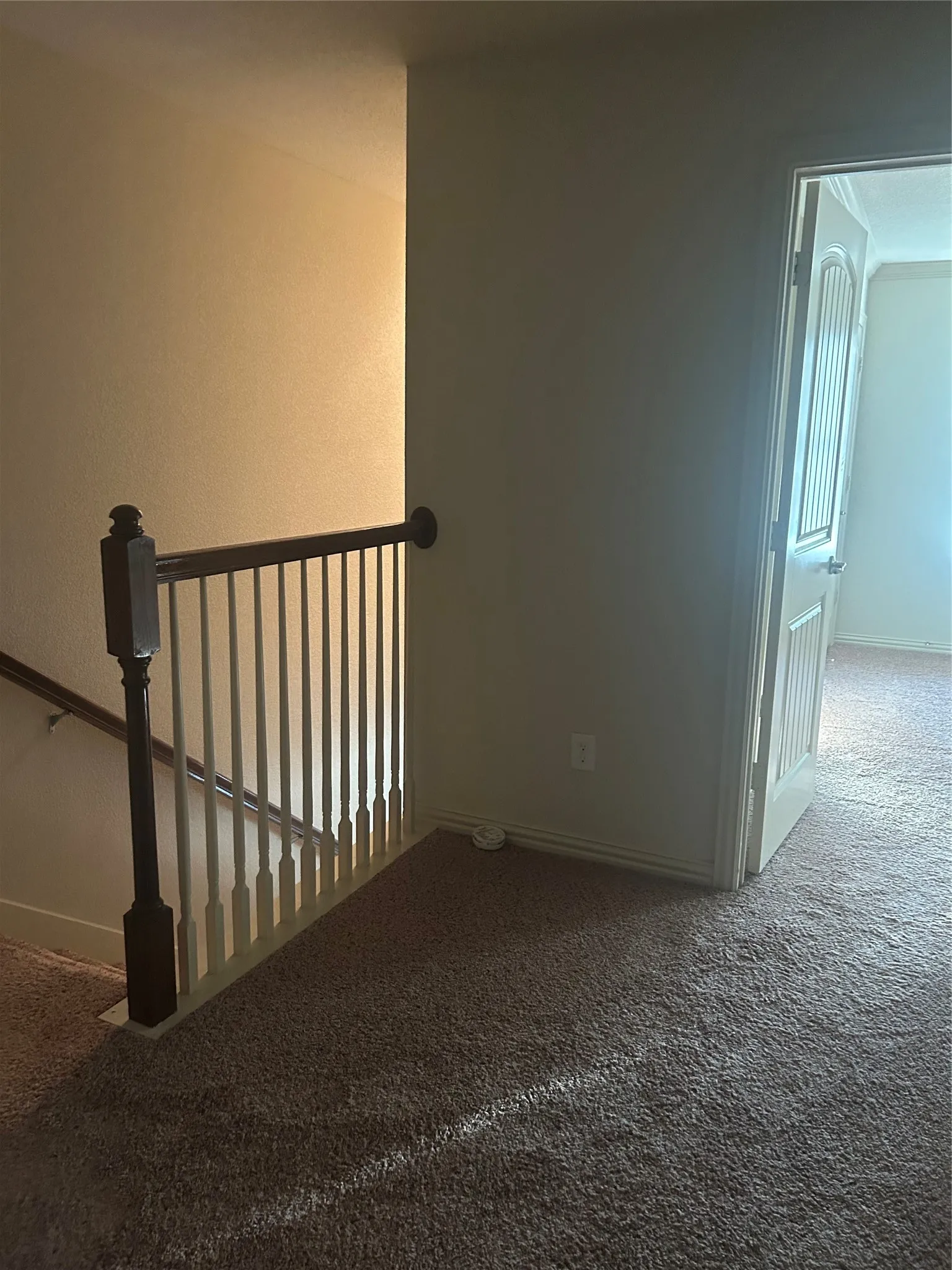 Small landing at top of stairway leading to Primary Bedroom with ensuite Bathroom