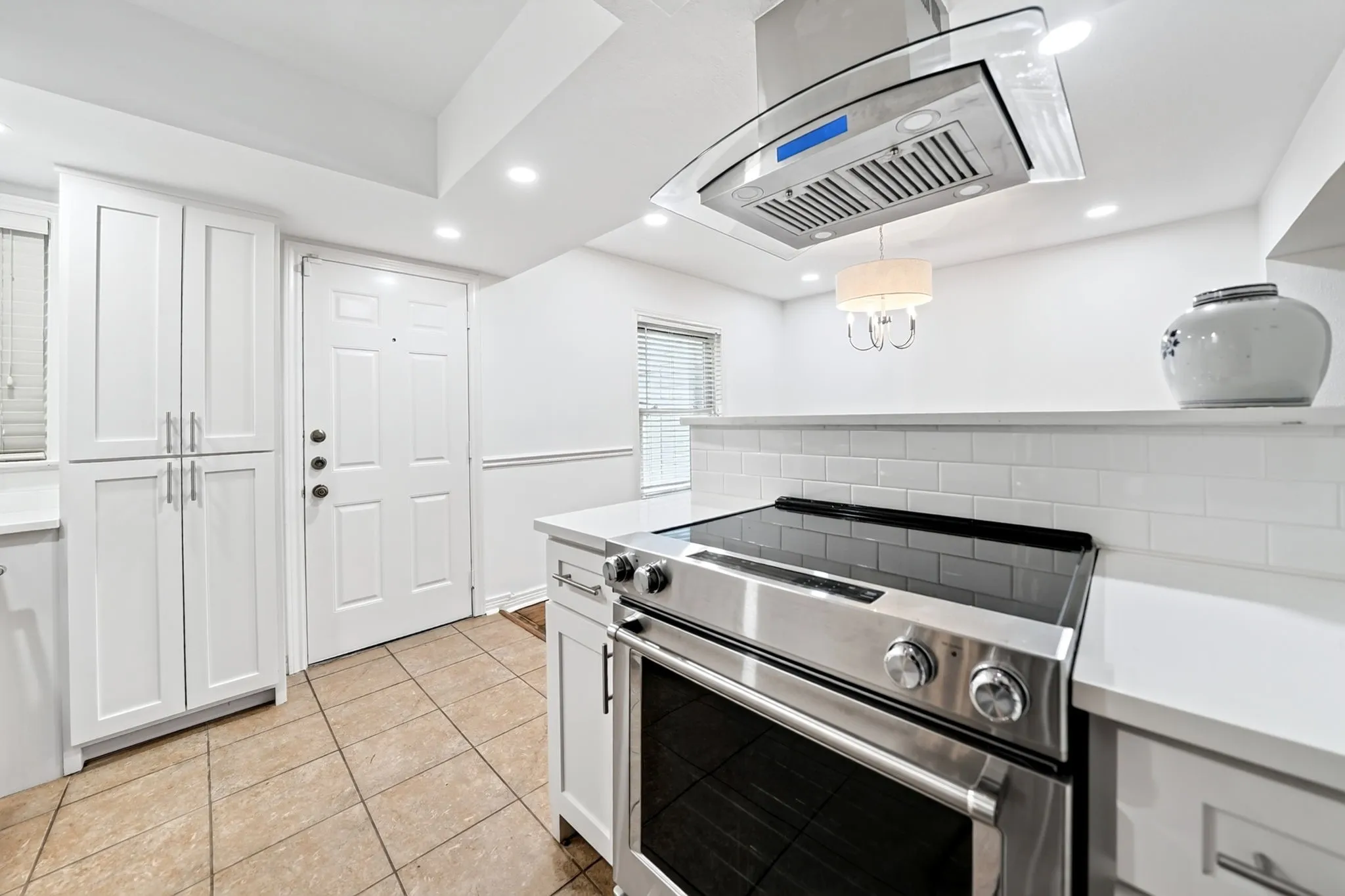 Stylish chimney style vent presides over the stainless steel electric range.