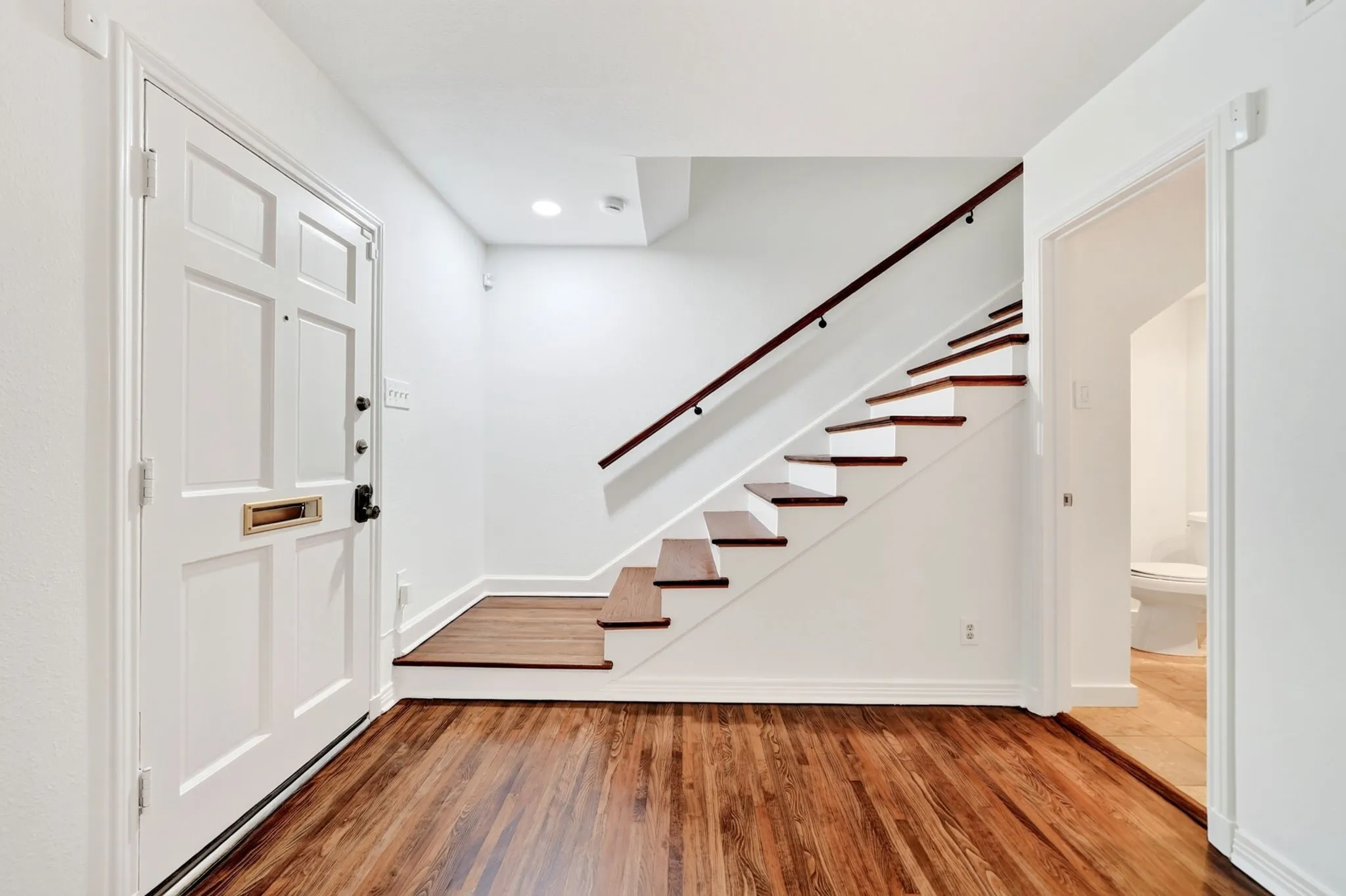View of the entry. Powder bathroom is to the right.
