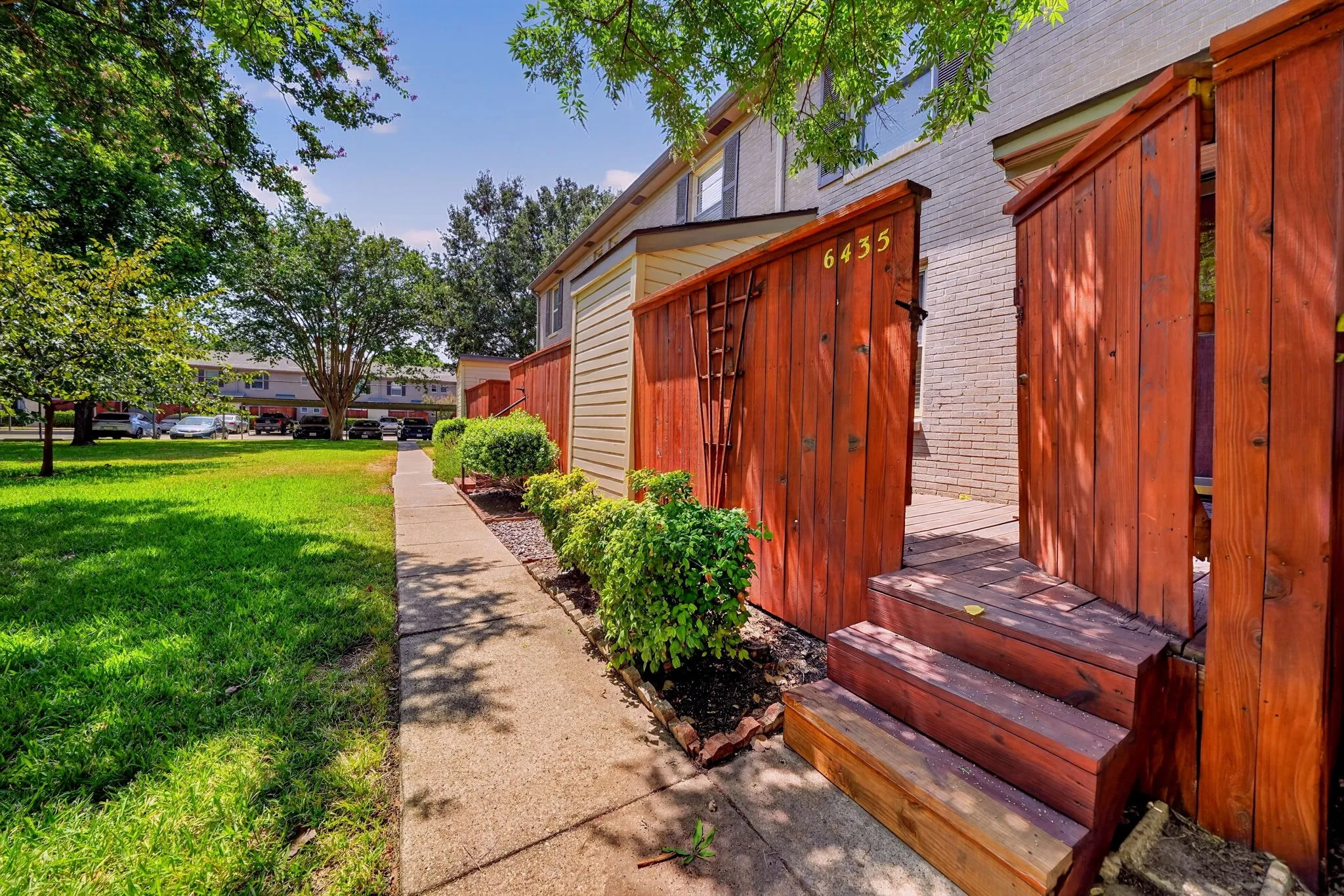 Back steps lead to the community greenbelt at the rear of the property.