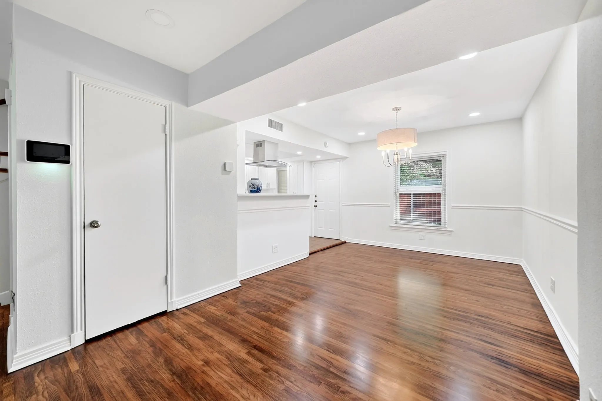 The combined living and dining room space includes a convenient coat or storage closet.