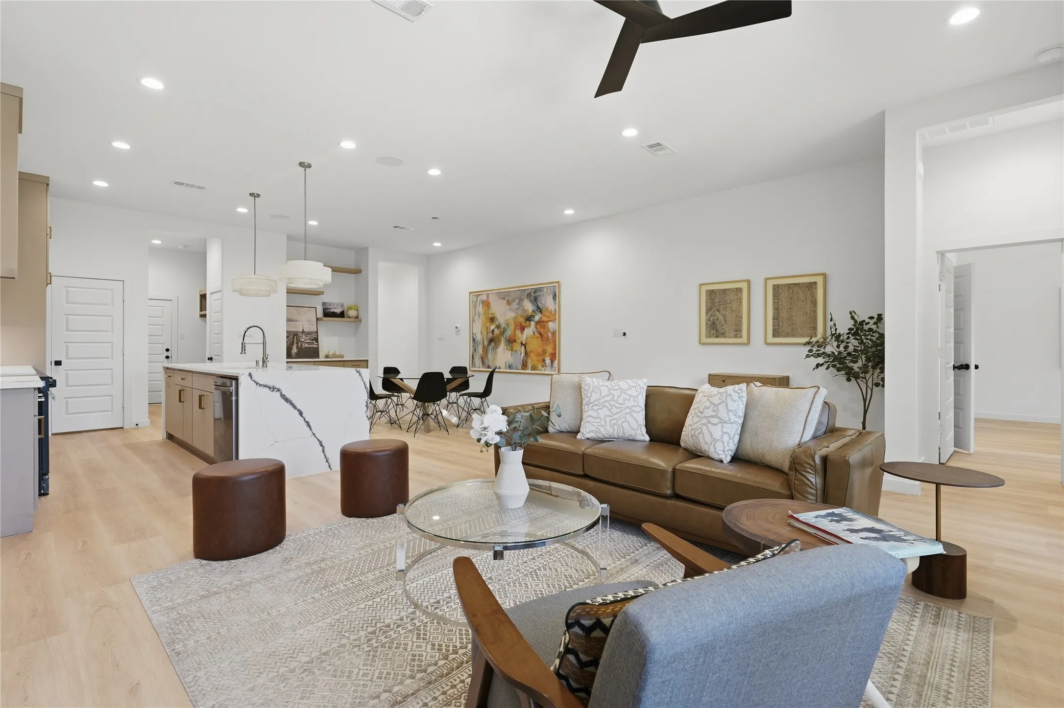 Open-concept living space featuring wood-finish flooring, recessed lighting, and a modern ceiling fan