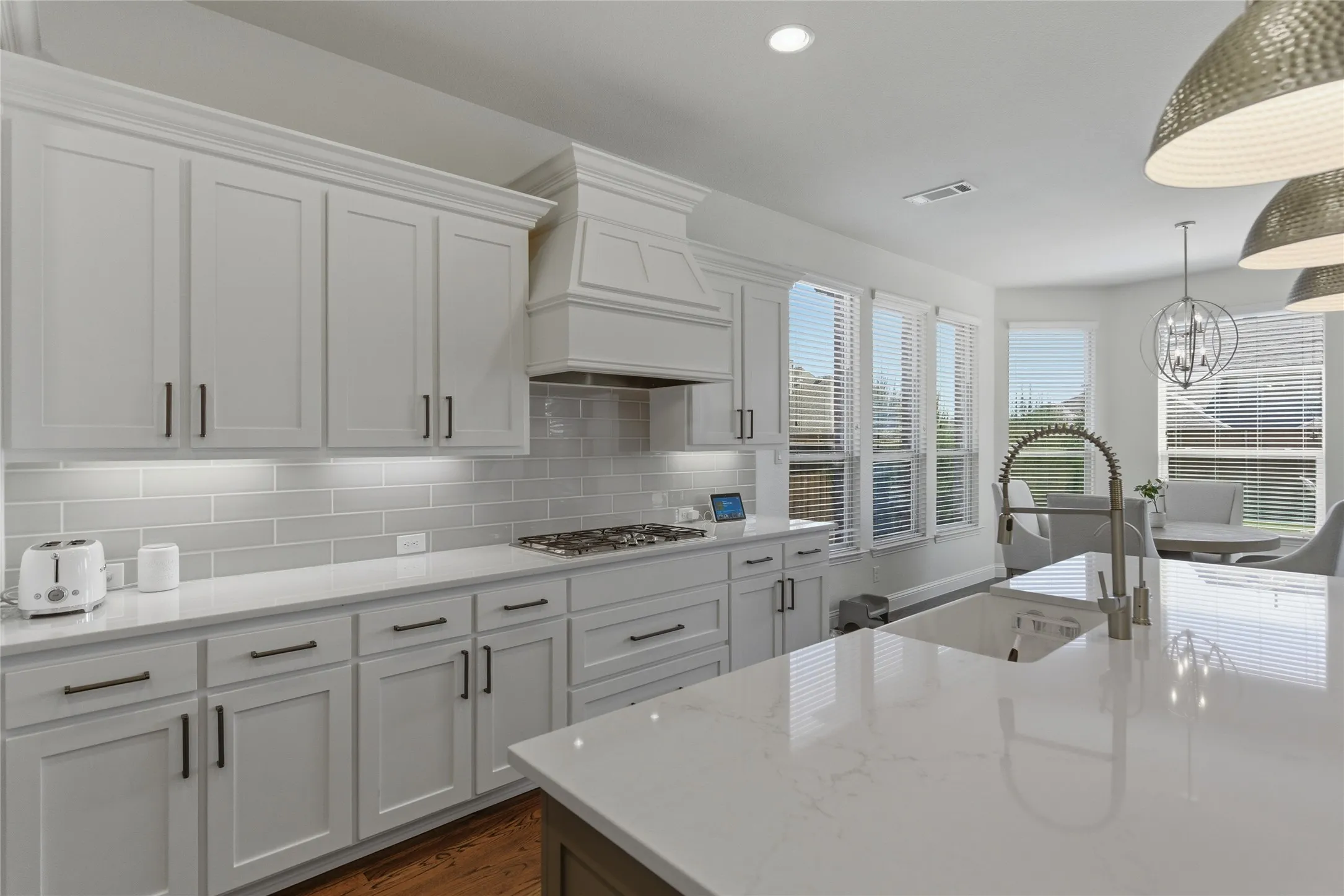 Large island, white cabinets and designer backsplash