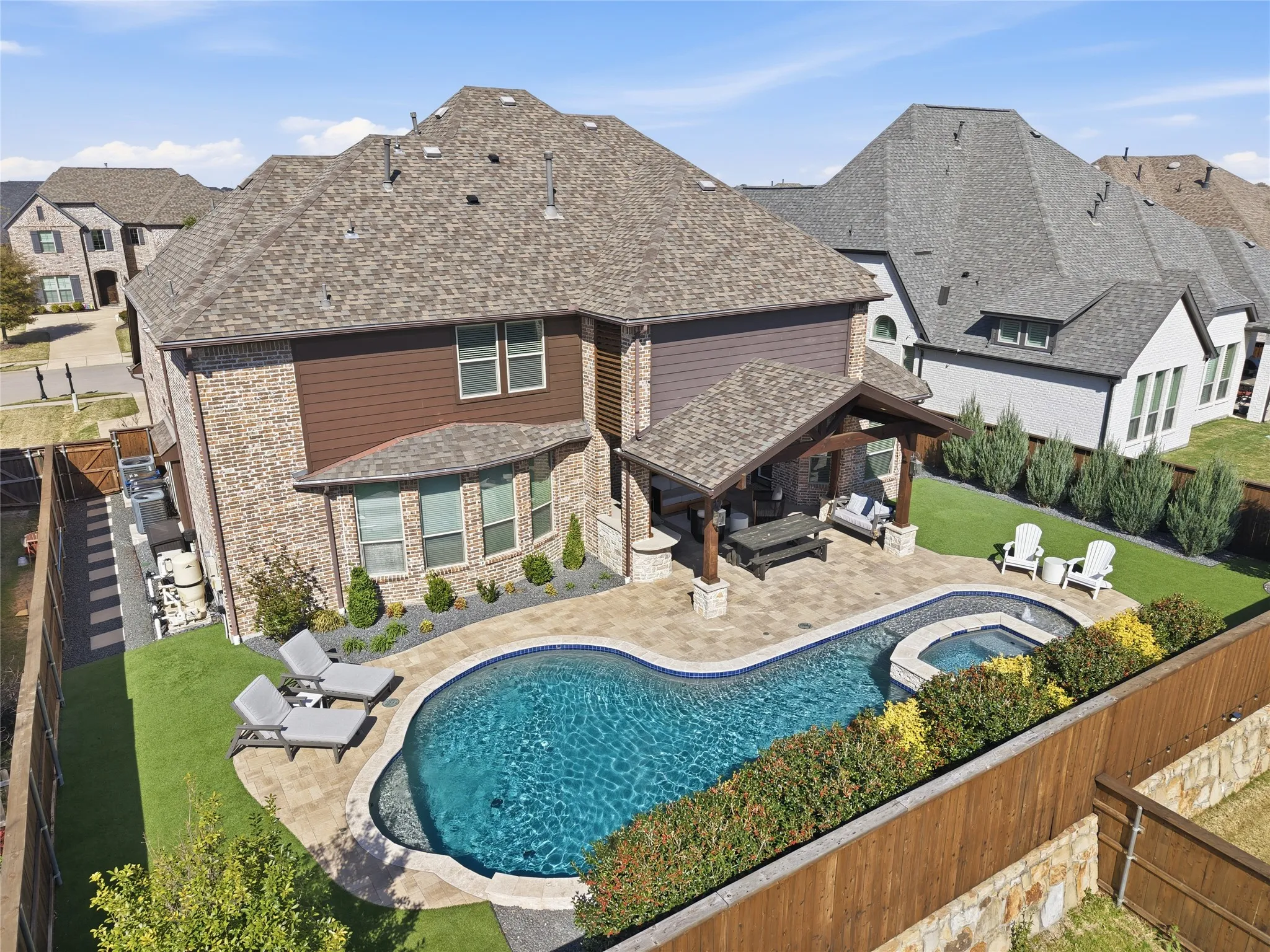 Enjoy outdoor living with sparkling pool, spa and covered patio