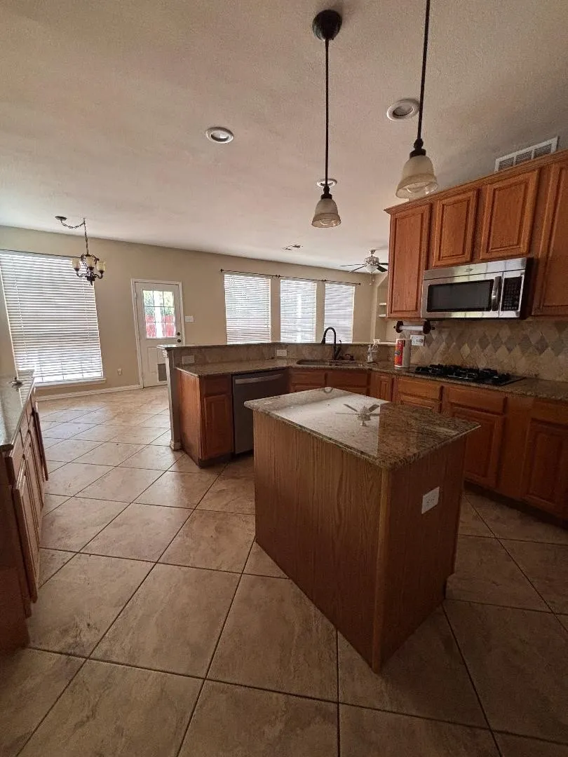 Kitchen leads to breakfast area and outside space.