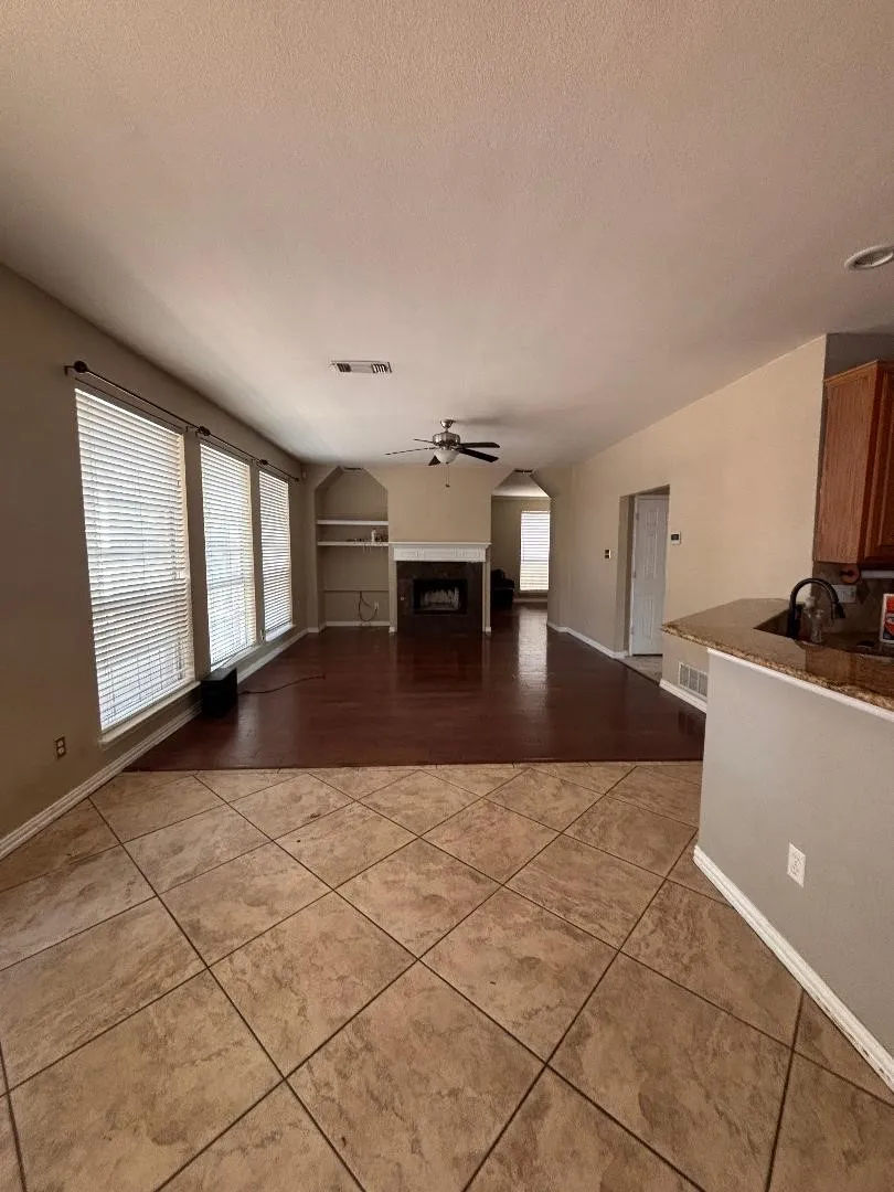 Living room off kitchen with fireplace.
