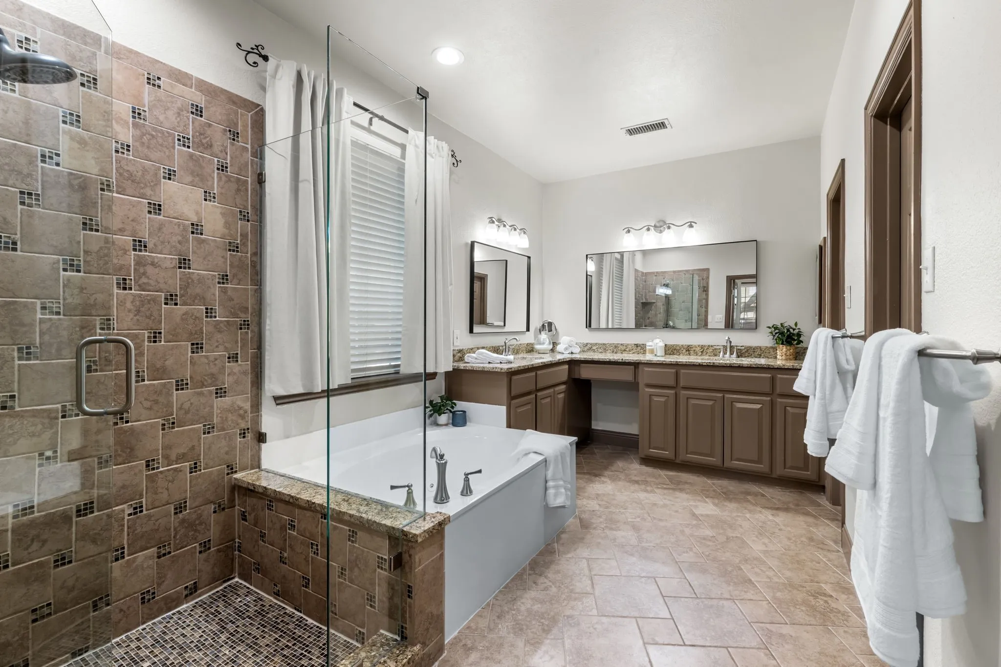 The well appointed ensuite bath offers a walk in shower and deep jetted tub.  His and Her vanities as well as a knee hole for sitting and preparing for the day!