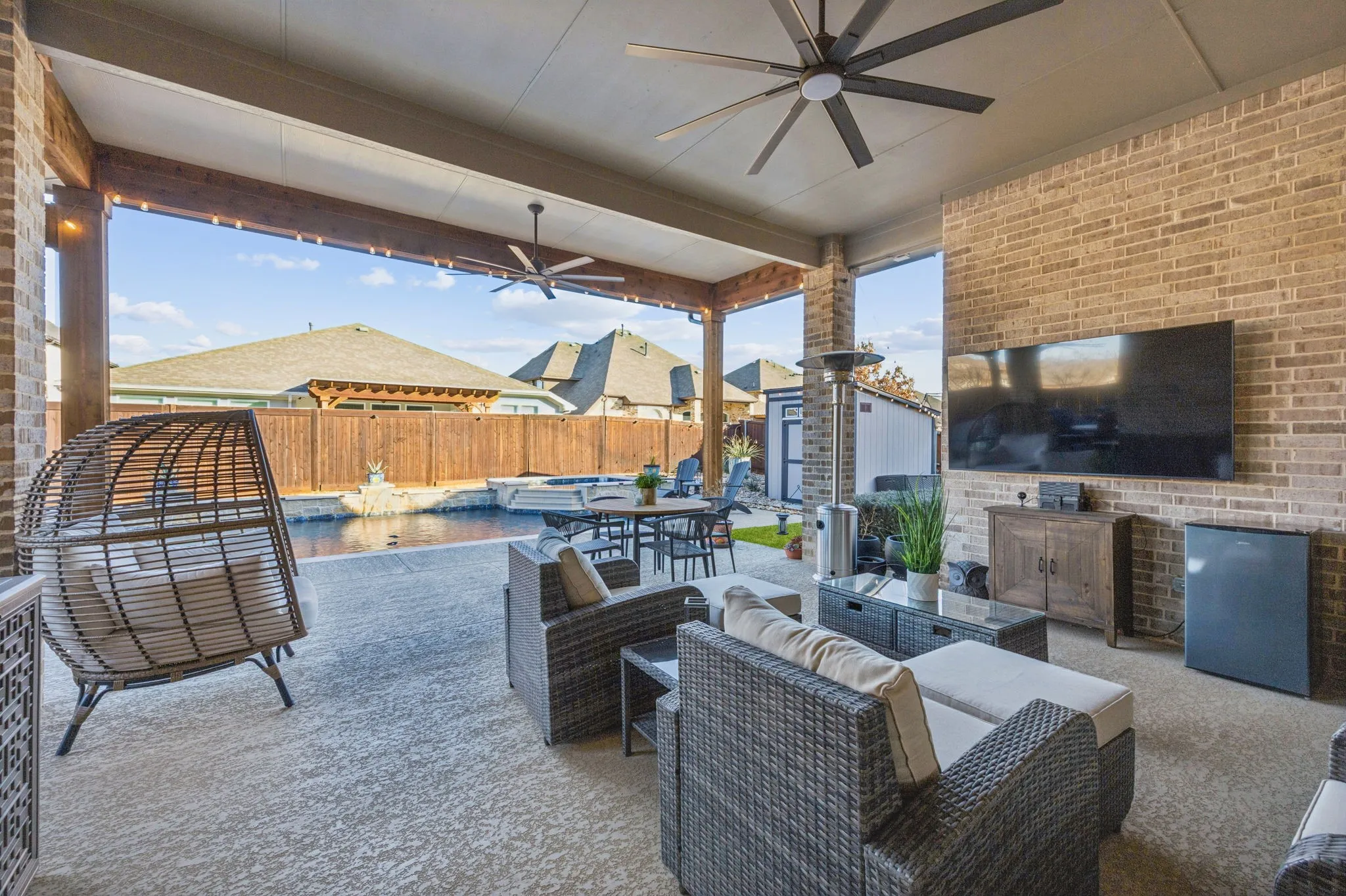 Covered Patio And Cedar Pergola Accented By River Rock Landscaping
