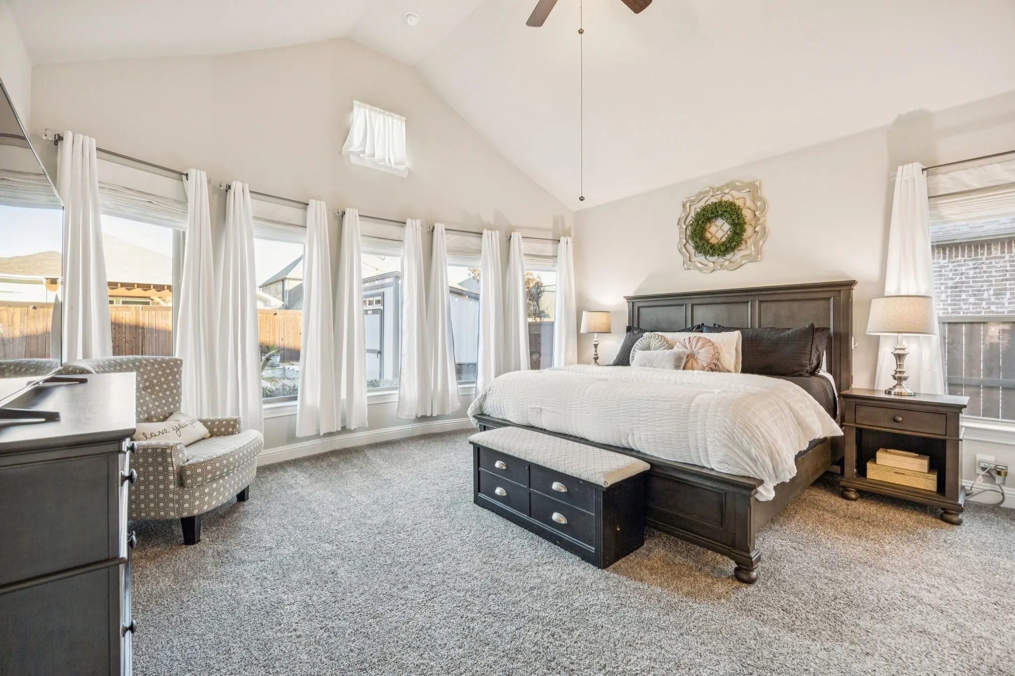 Oversized Primary Suite Highlighted By Bowed Windows With Tranquil Pool Views