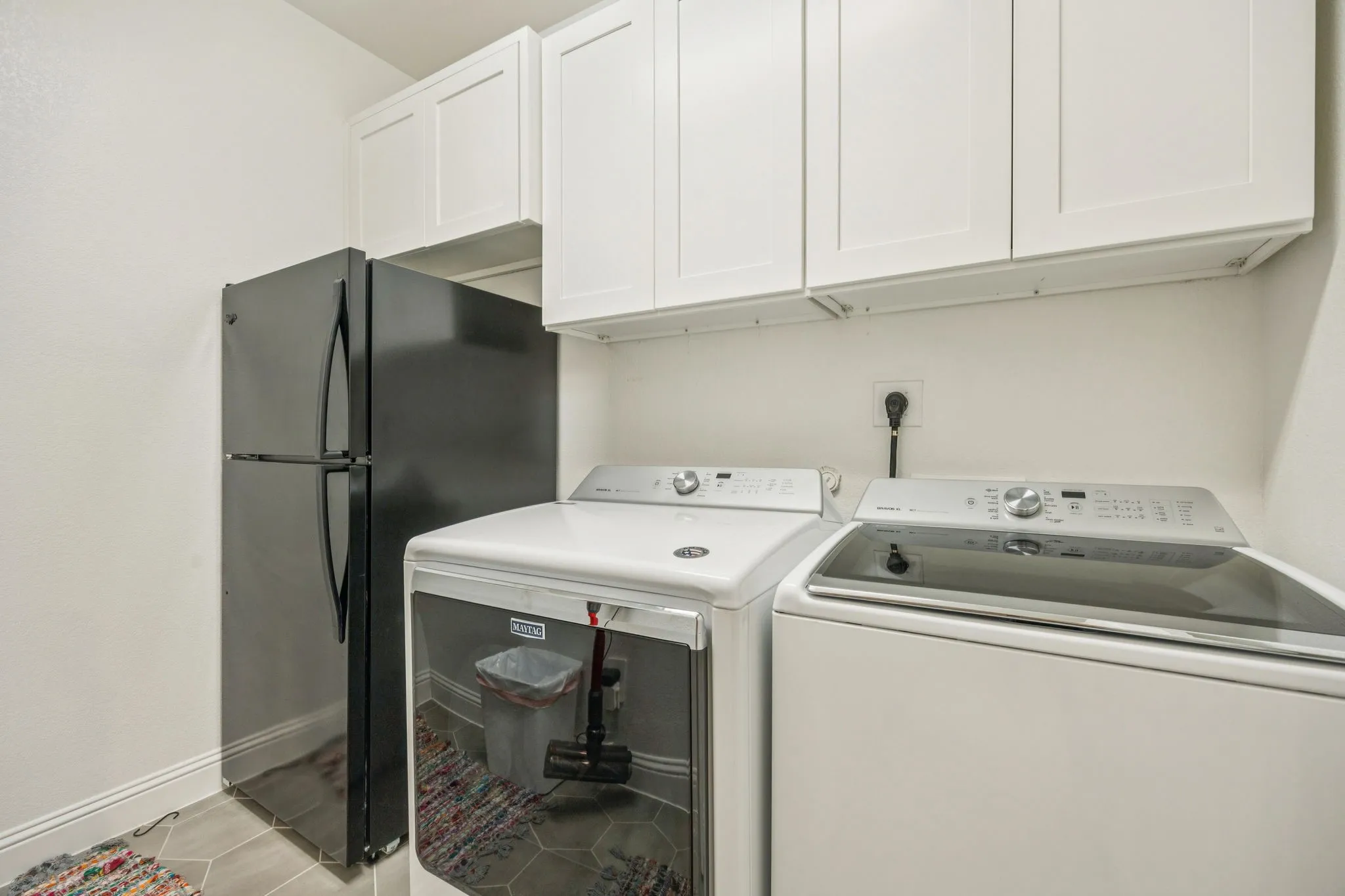 Large Laundry Area Featuring Built-In Cabinetry