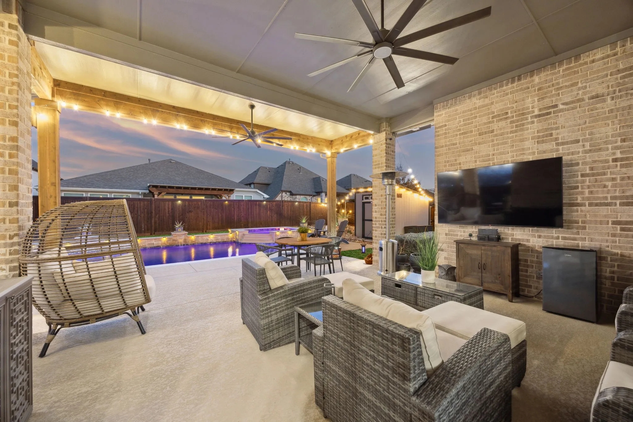 Extended Covered Patio With Cedar Pergola And River Rock Landscaping