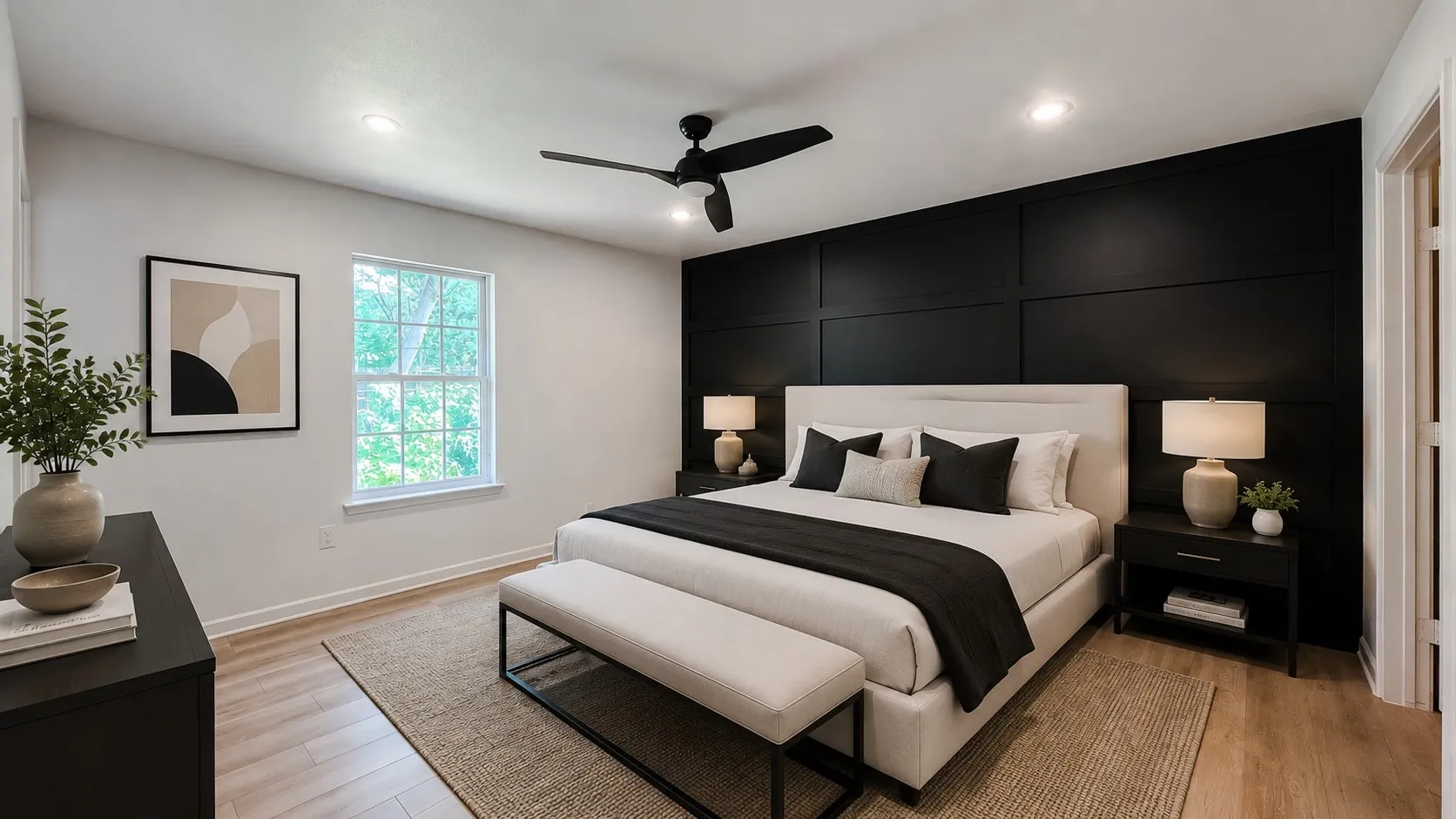 Spacious bedroom featuring a stylish accent wall, ceiling fan, and great natural light.
