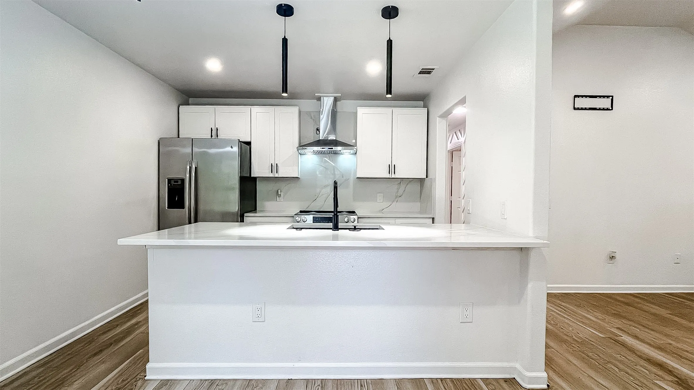 Modern kitchen featuring crisp cabinetry, updated fixtures, and a functional central island.