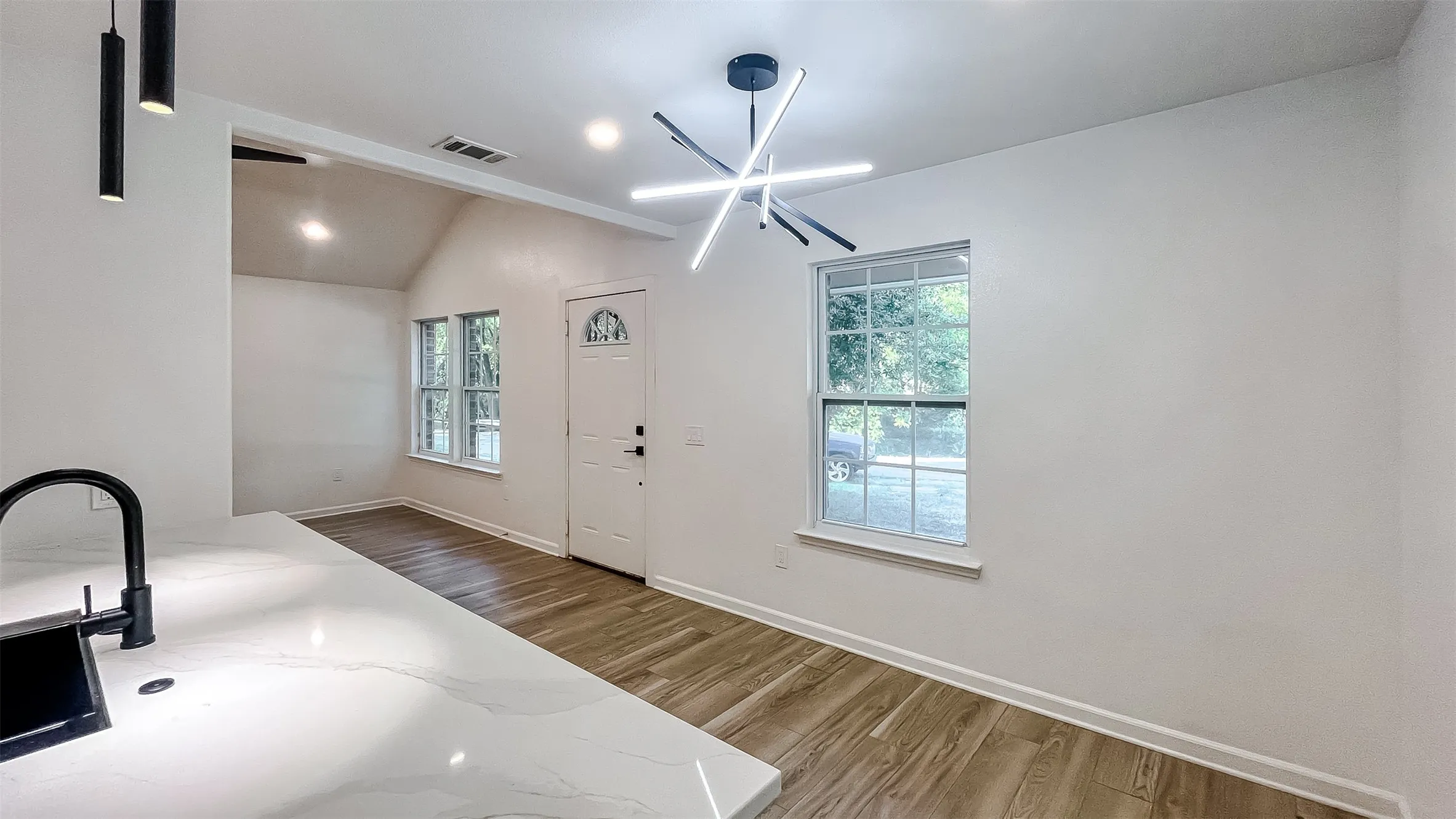Bright main living area featuring clean lines, modern lighting, and a functional layout.