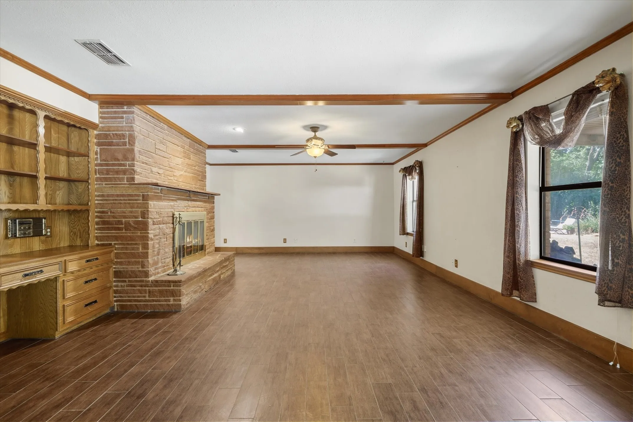 Beautiful stacked stone fireplace and hearth and built-in desk, bookshelves, and gun case with a working, all-house intercom/radio system.