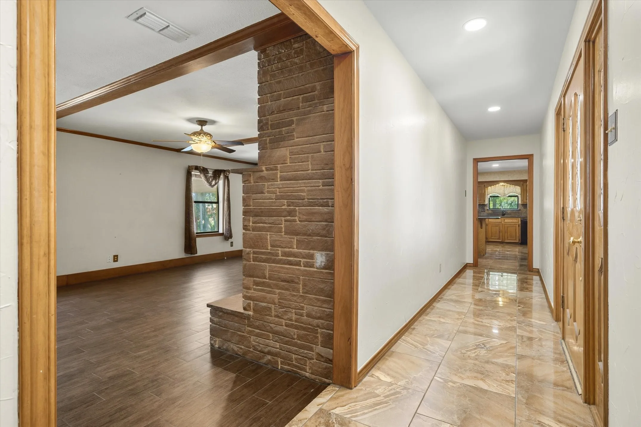 Entry -- leads into the living room straight ahead, down the hall to the kitchen one way, and down the hall to the bedrooms the other way (not shown).