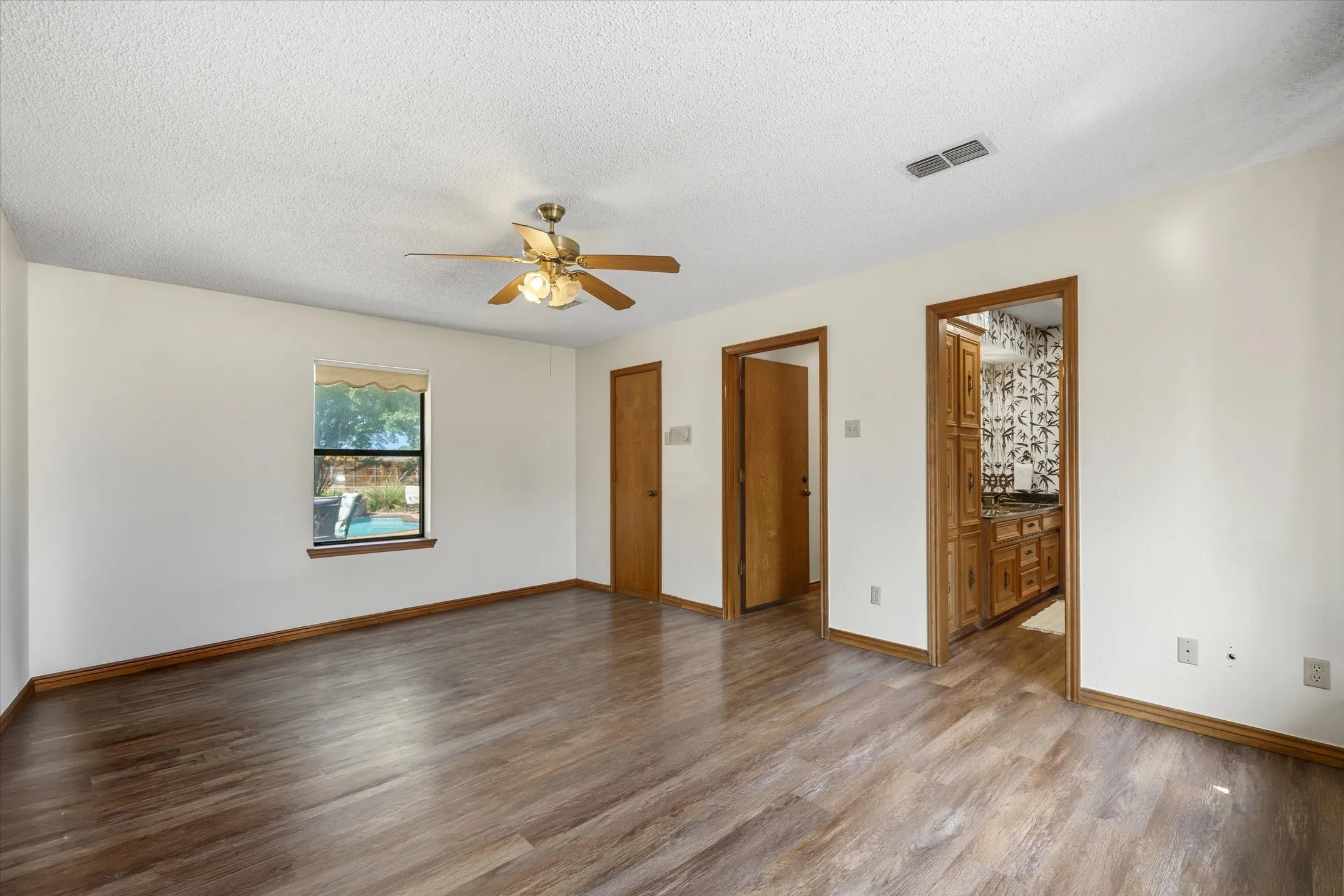 Primary bedroom suite -- looks out over the pool area