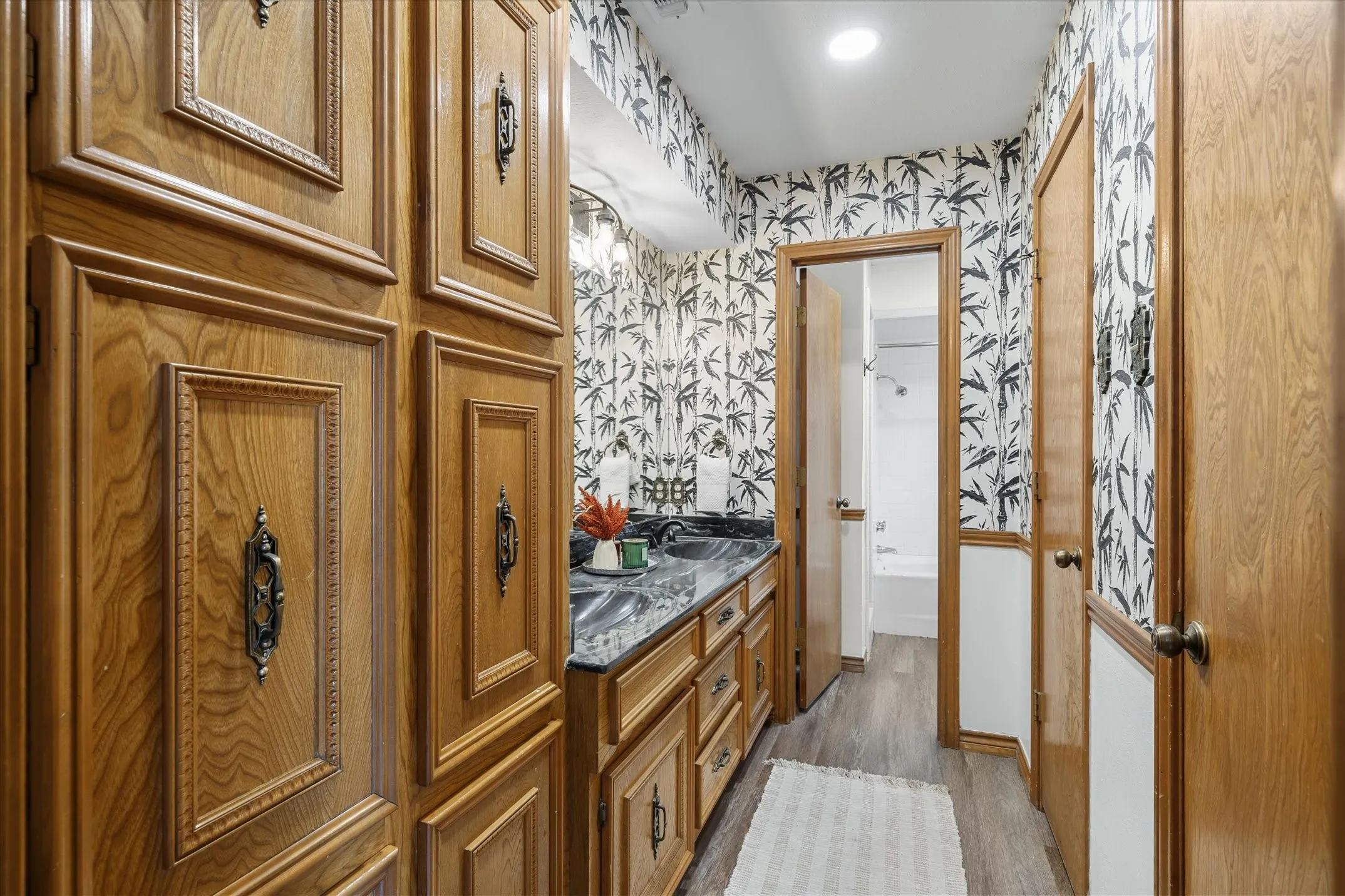 The primary bath features extra cabinetry for storage, two walk-in closets, double sinks