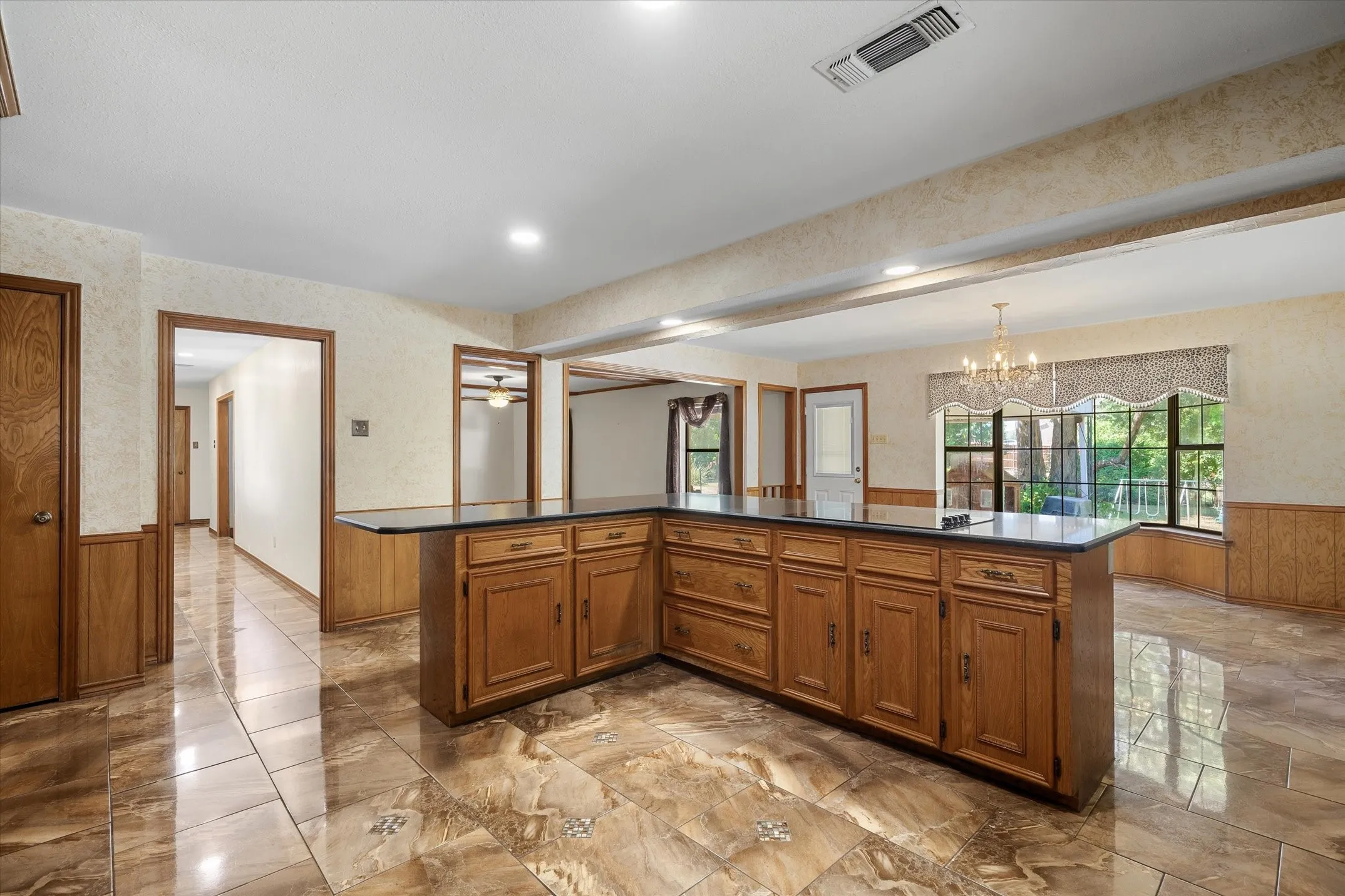 The kitchen is positioned to allow for easy access from front door, living area, dining area, and laundry room.
