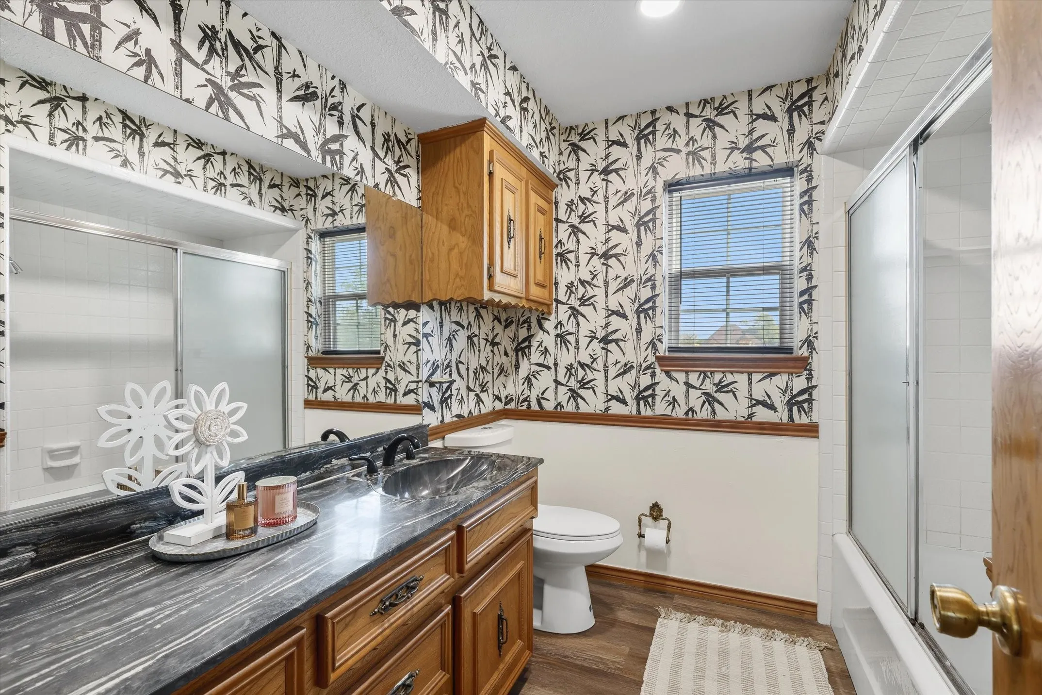 The secondary bedroom features a large vanity and a tub/shower combination
