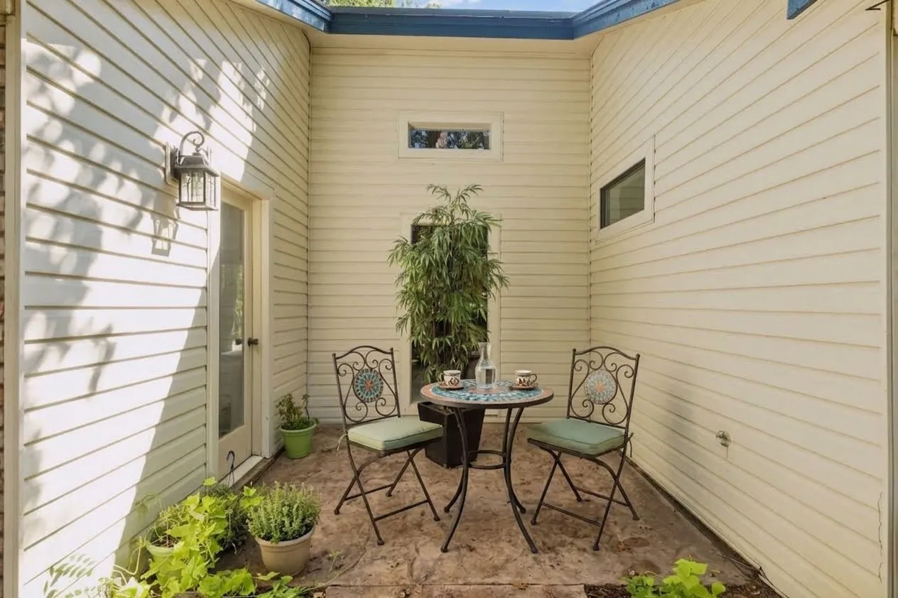 Digitally Staged. Side Patio off Living Room.