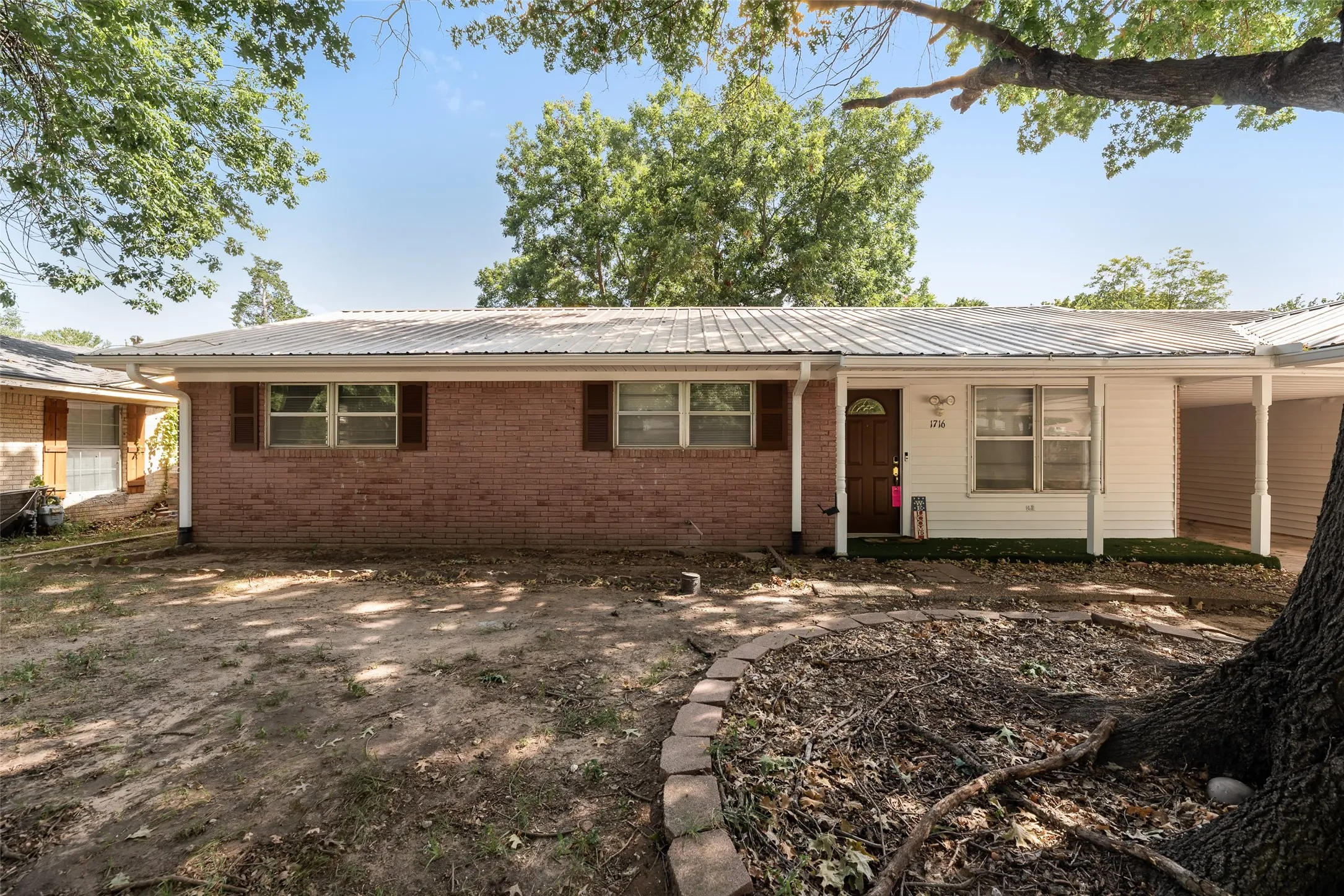 Brick and siding exterior with a metal roof