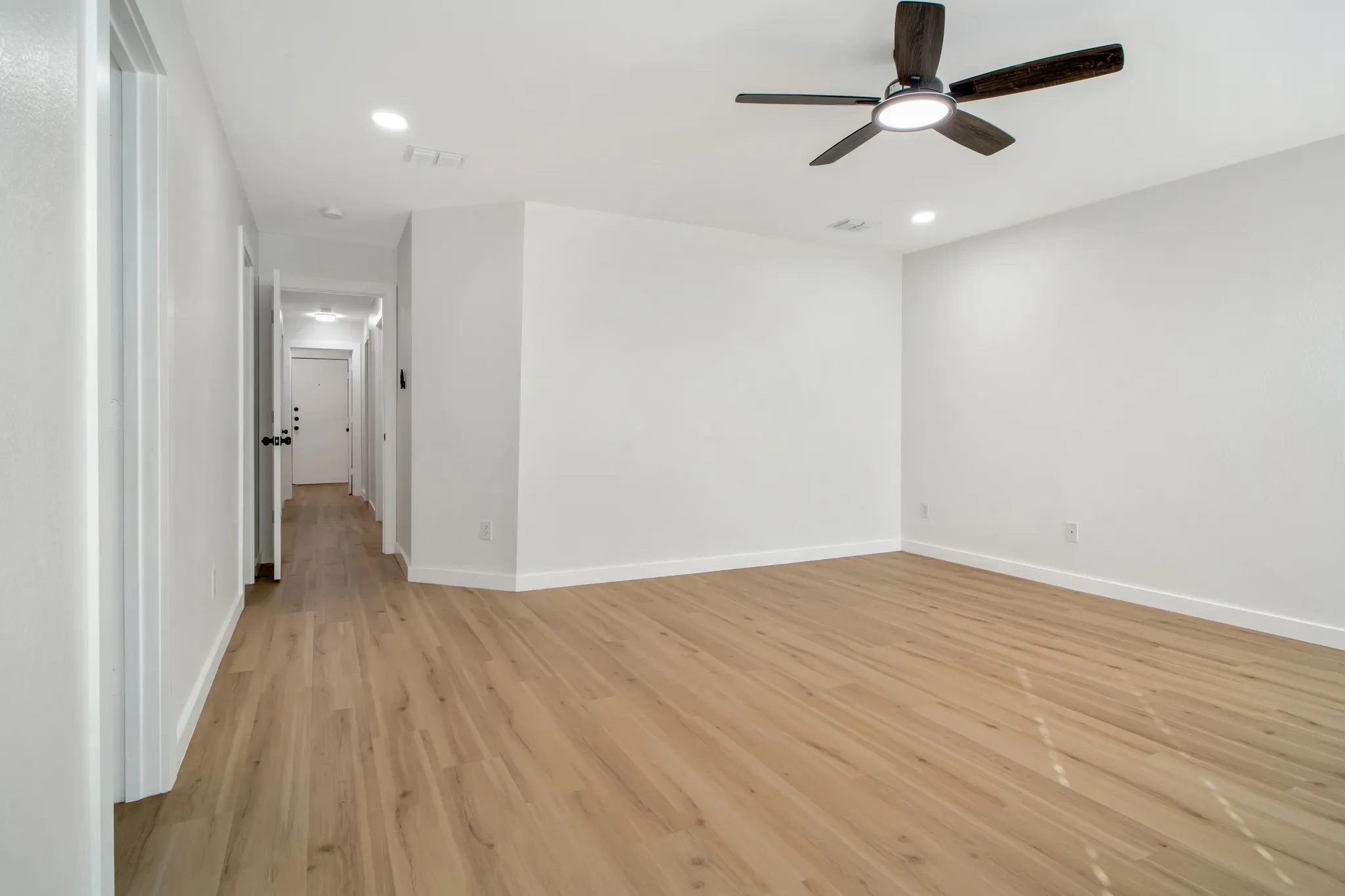 Wood-finish flooring with crisp white walls and trim