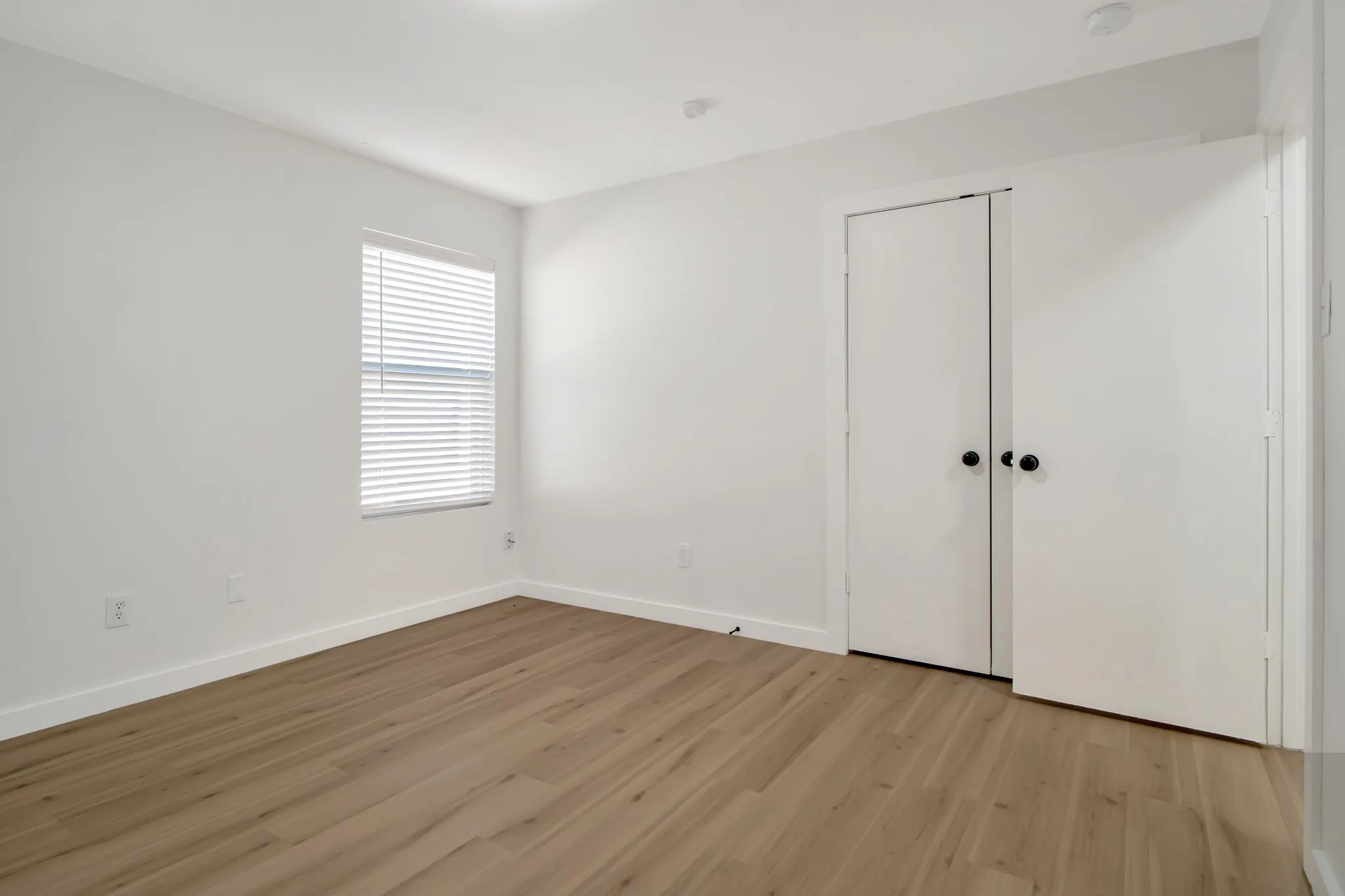 White walls with wood-finish flooring
