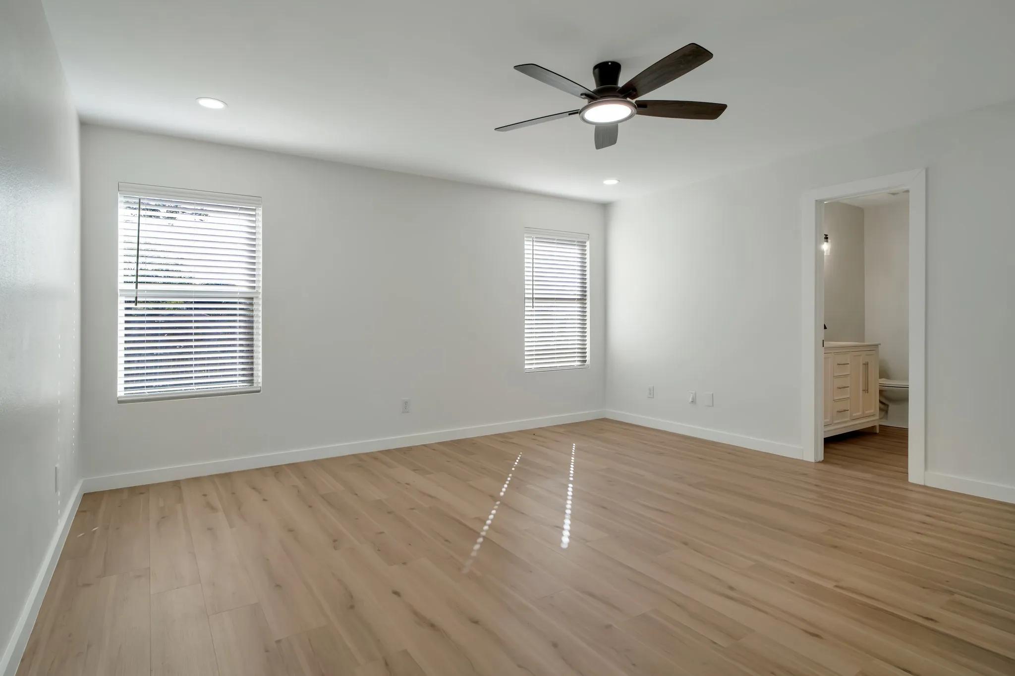 Light wood-finish flooring with white walls