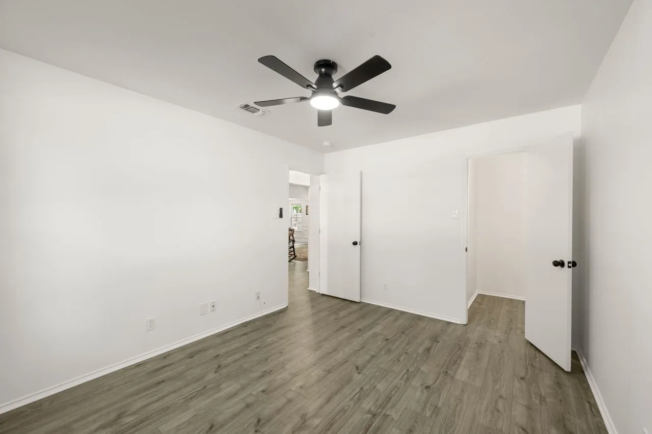 Wood-finish flooring with white walls and trim