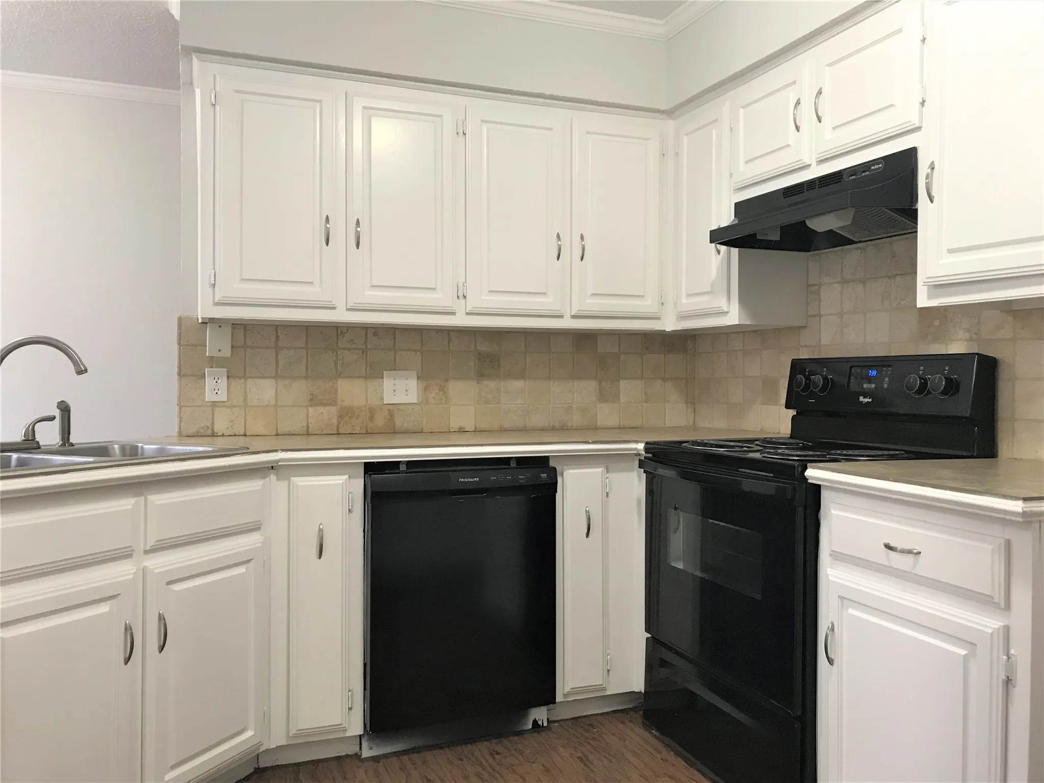 Kitchen with tile countertops and backsplash