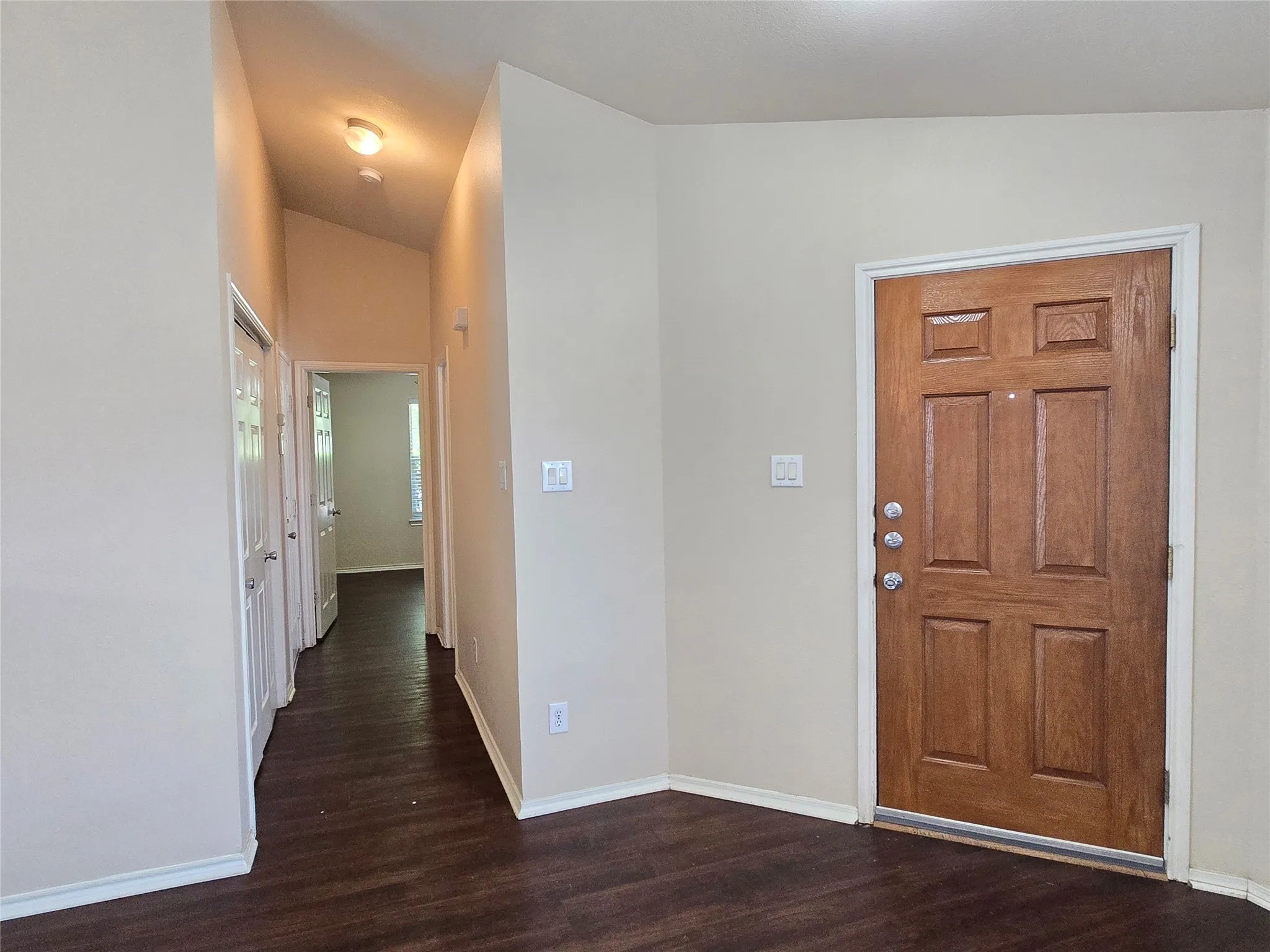 Main entry door near the secondary bedroom hall, opens to the living room.