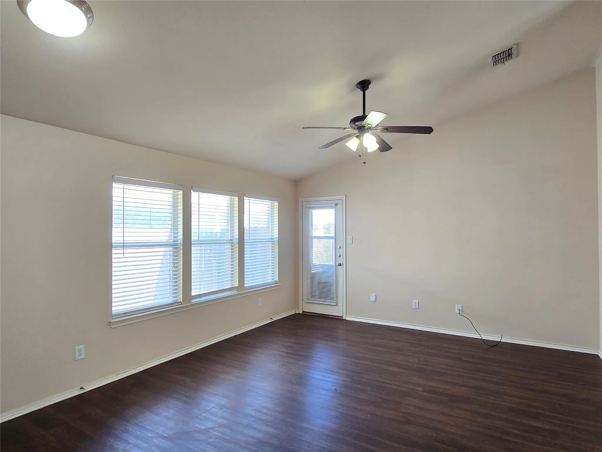 Enter into the living room, complete blinds and ceiling fan for your comfort. Back door leads to a covered back patio and includes a storm door.