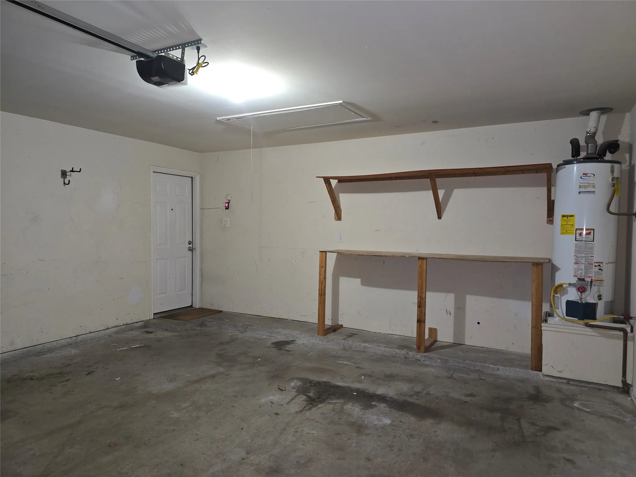 Two-car garage also has built-in shelves and a gas water heater.