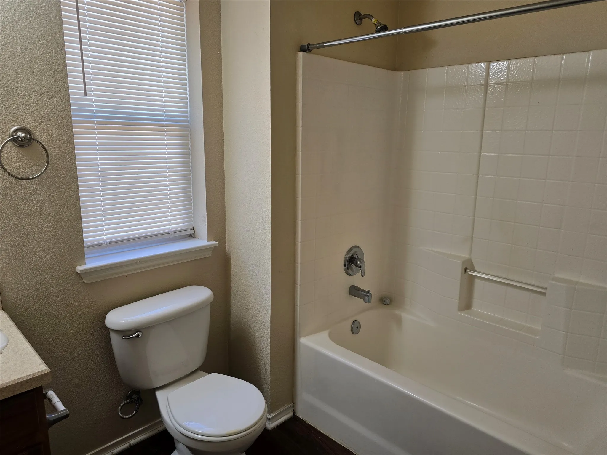 This spacious hall bathroom has its own combination bathtub and shower.