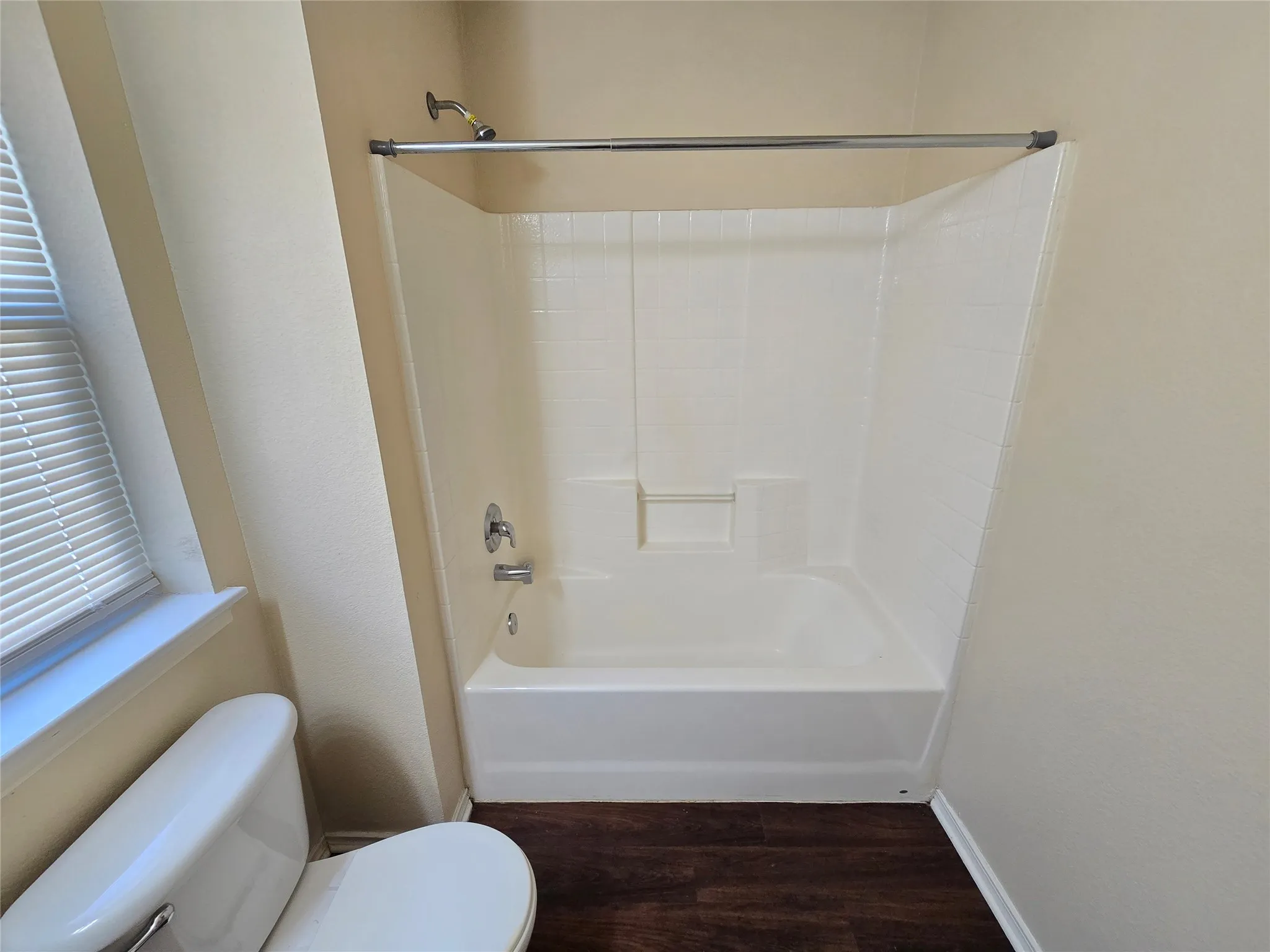 Wood-look luxury vinyl plank flooring continues into even the bathrooms!