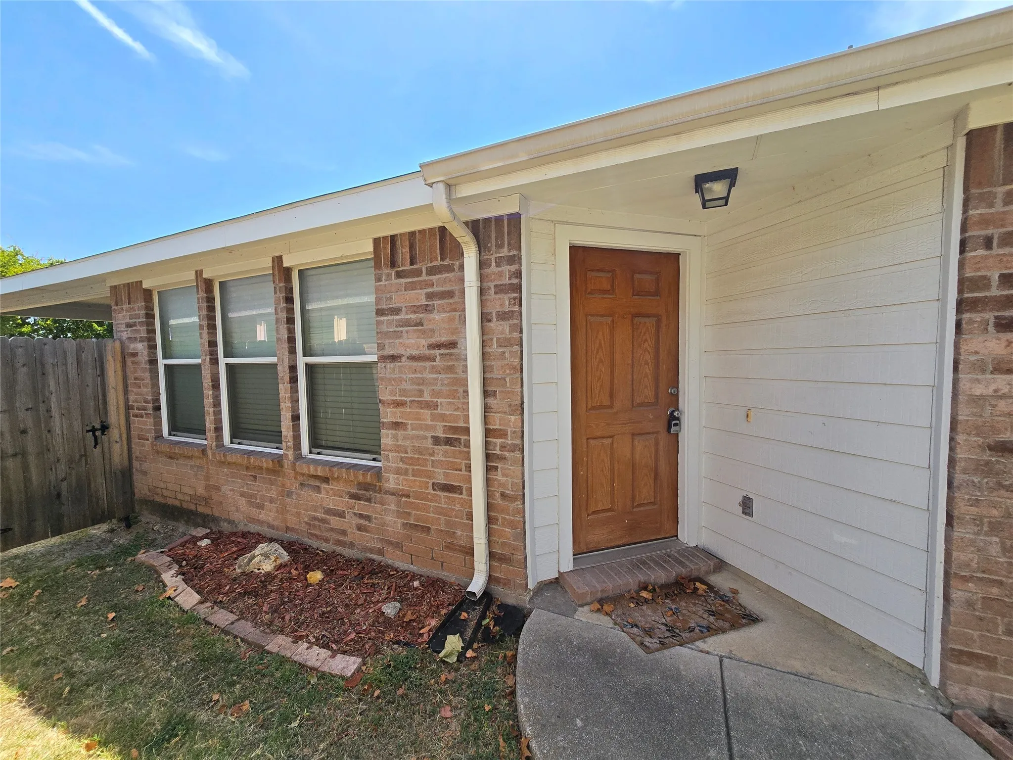 Covered main entry is tucked on the side of the home.
