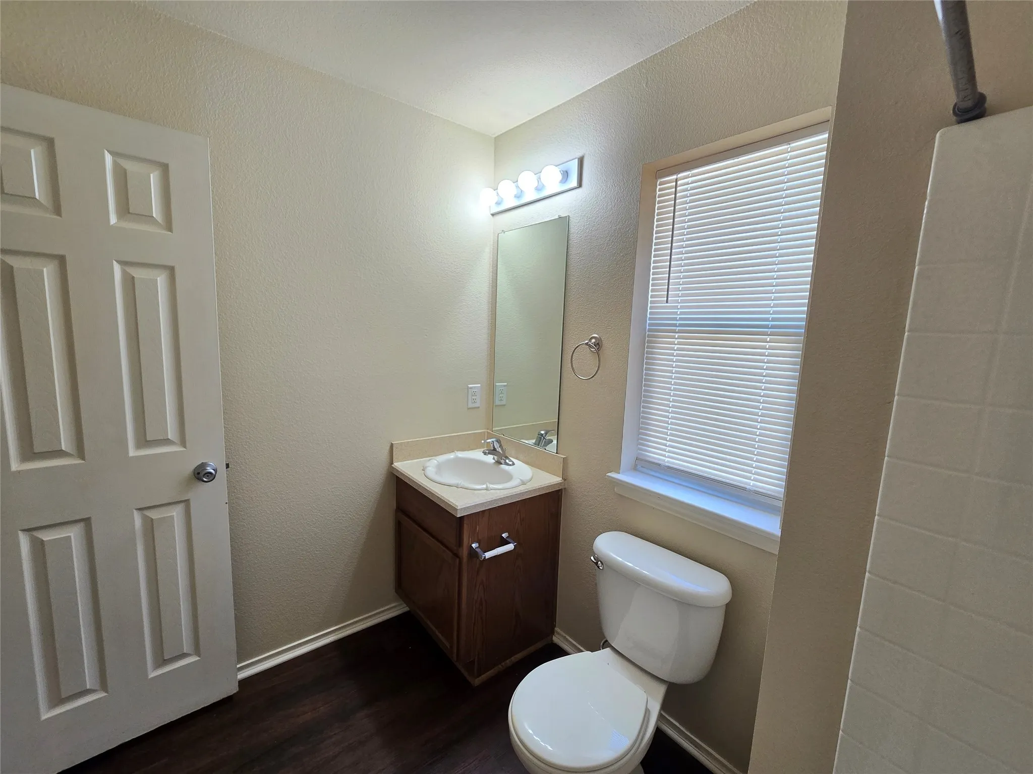 Hall bathroom has a storage vanity, plus a window for natural light--with privacy window and blinds.