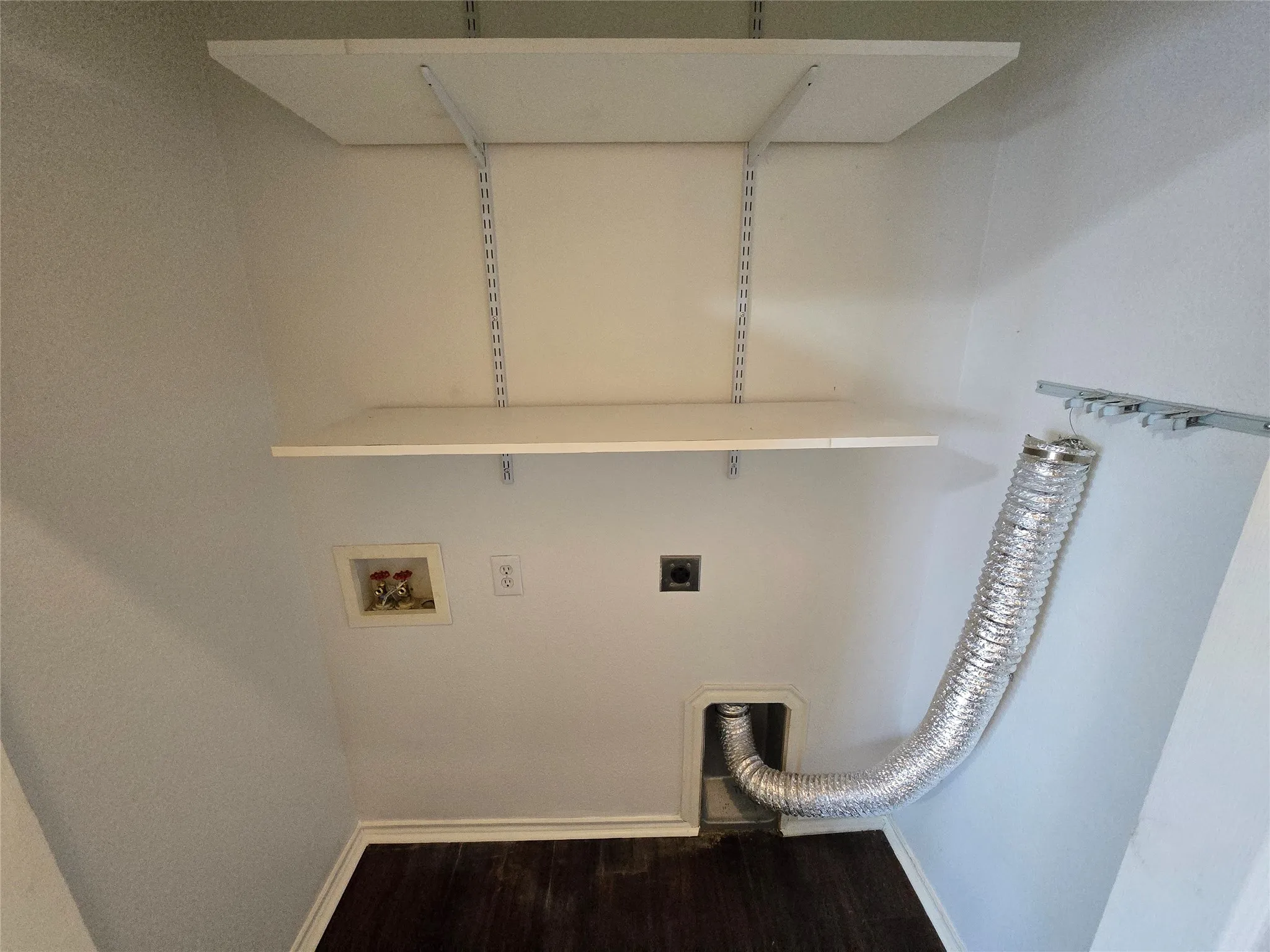 Utility closet near garage entry has customizable shelving and room for your favorite full size washer and electric dryer. There is also a vent fan inside the utility closet to control indoor humidity while doing your laundry.