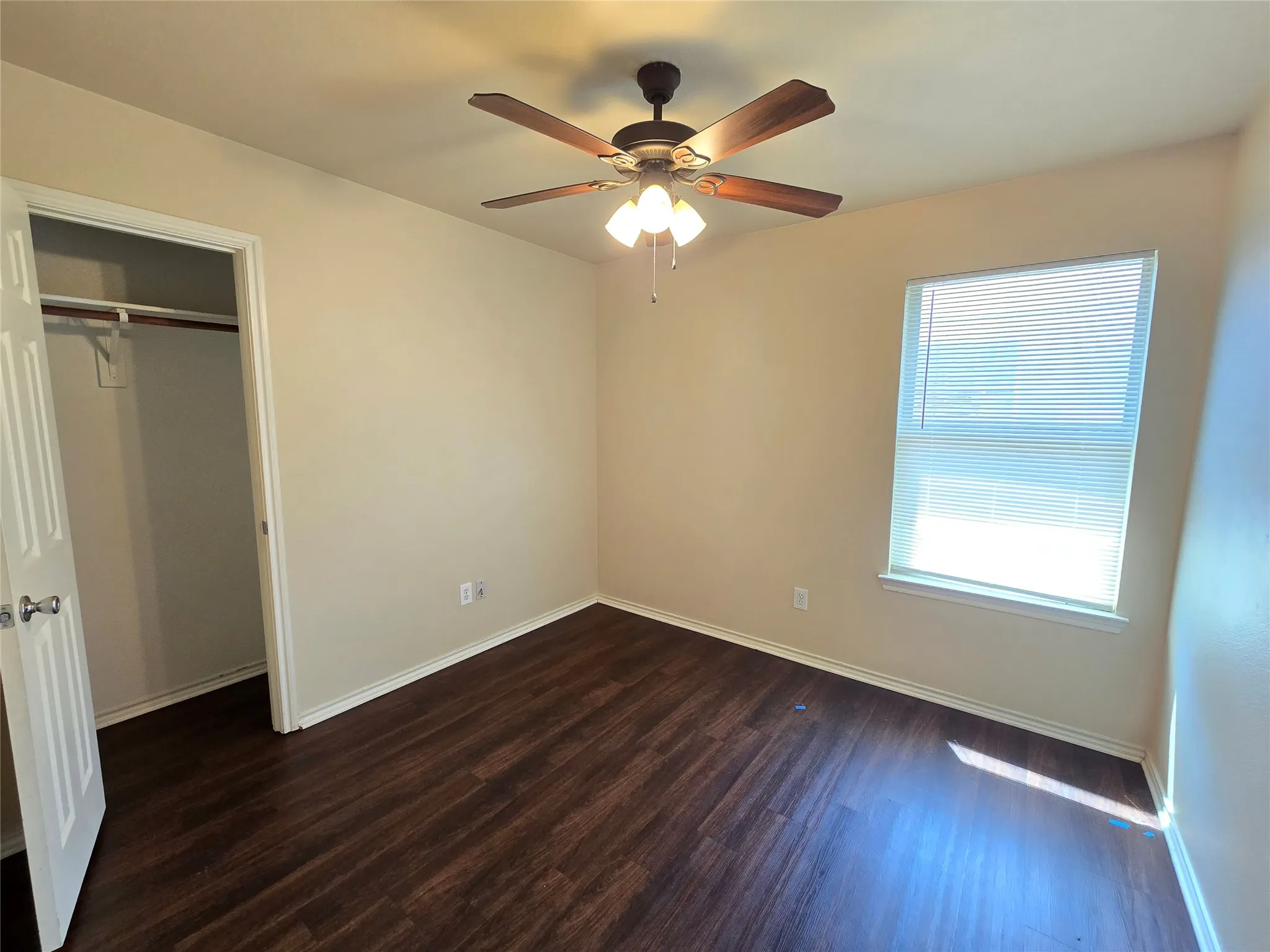 Bedroom 2 features a walk-in closet, ceiling fan, and window blinds.