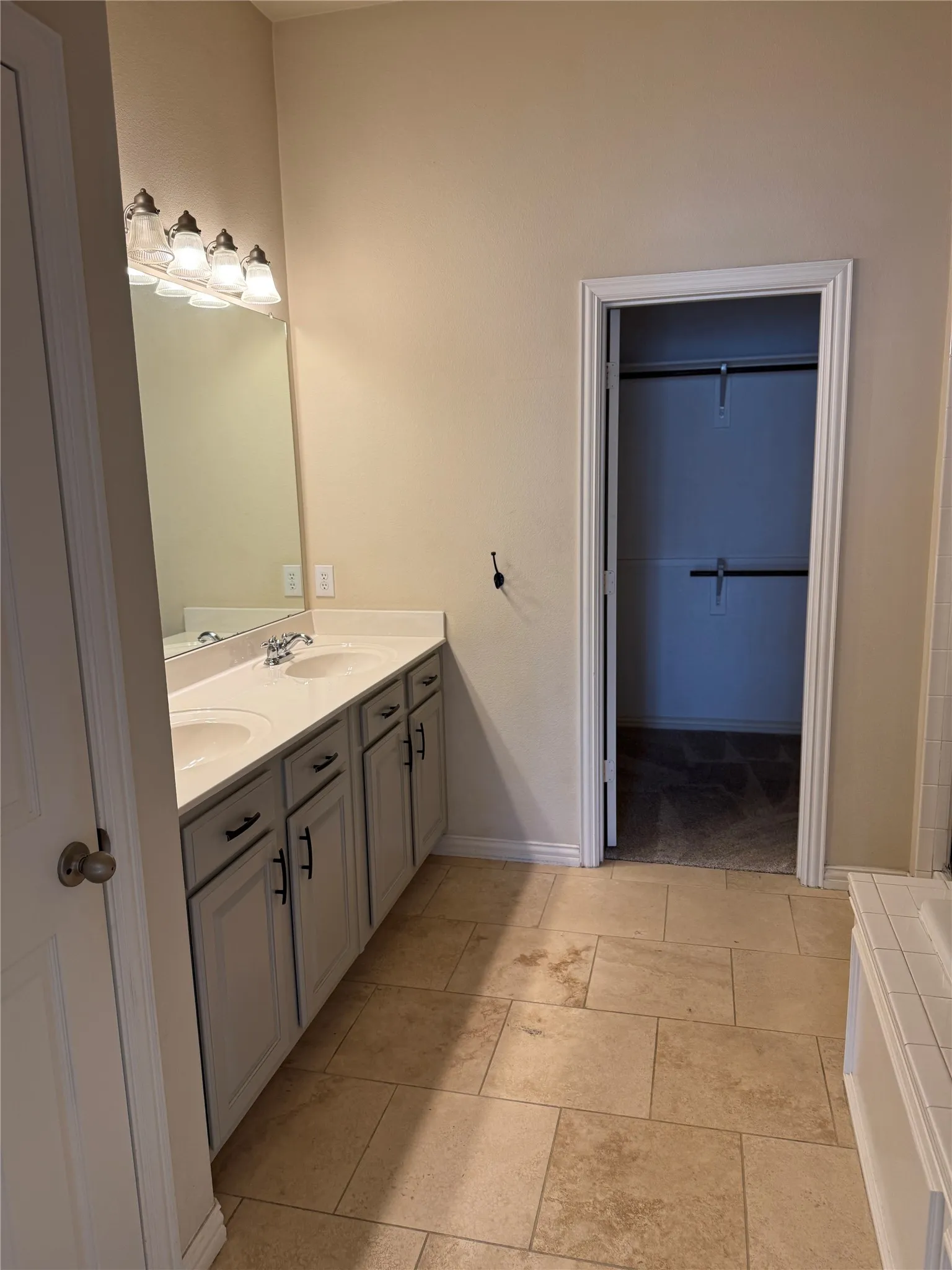 Primary Bathroom with double vanity, baseboards, and a Garden Tub, Separate Shower, Linen Closet and medicine cabinet.