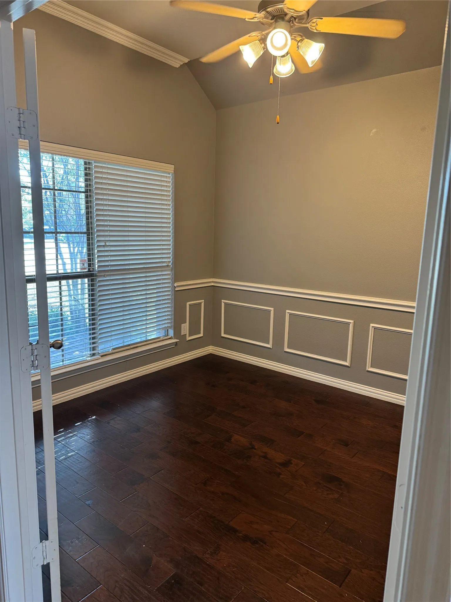 Office wood finished floors, crown molding, wainscoting, and ceiling fan
