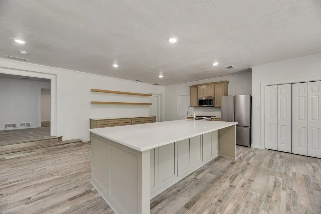 There is even storage in the kitchen island! And open shelving to display decor.
