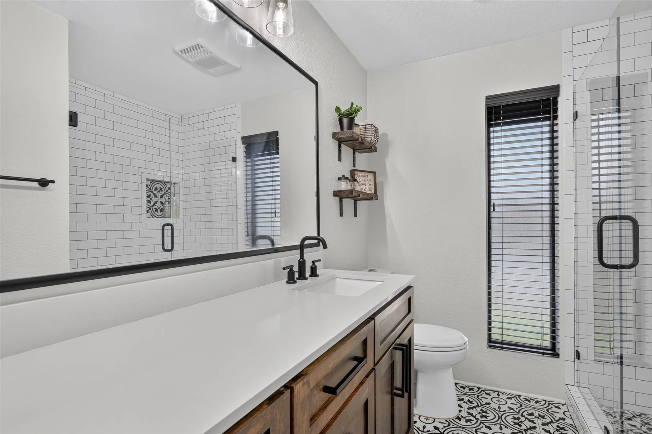 Spacious vanity with a white countertop and wood-finish cabinetry