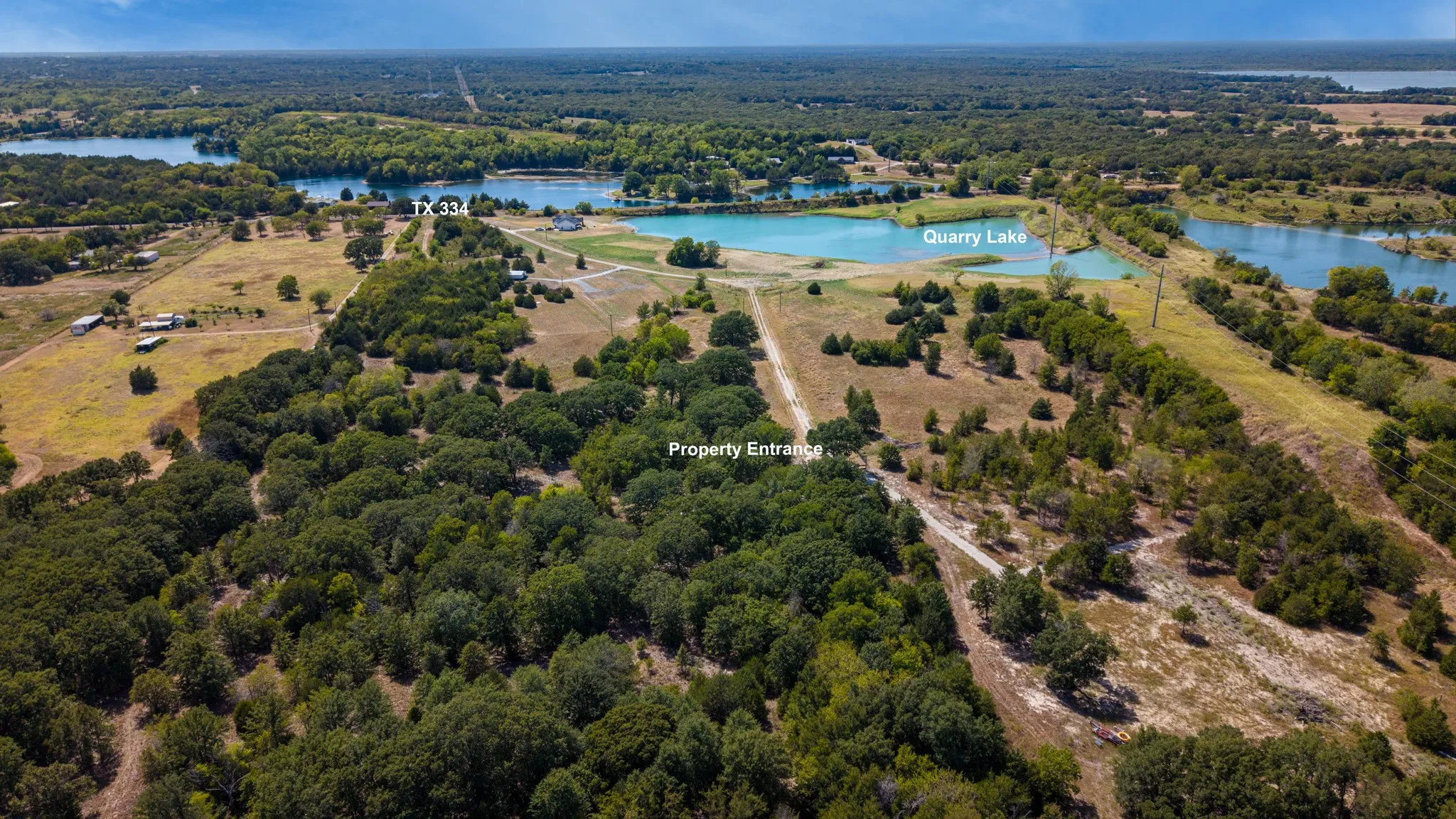 Extensive acreage featuring dense tree coverage, open clearings, and a defined property entrance