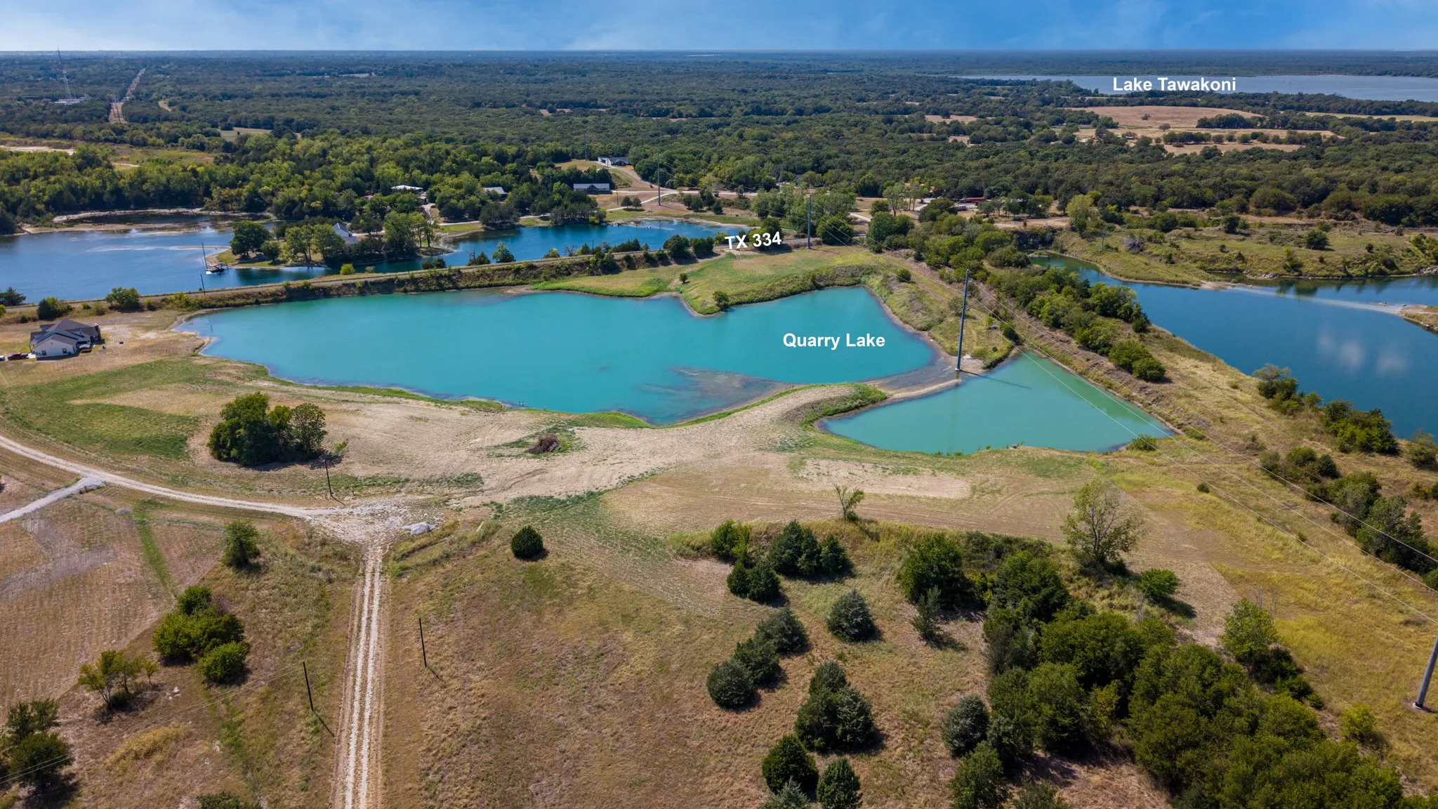 Expansive property featuring Quarry Lake, multiple bodies of water, and a tree-lined landscape